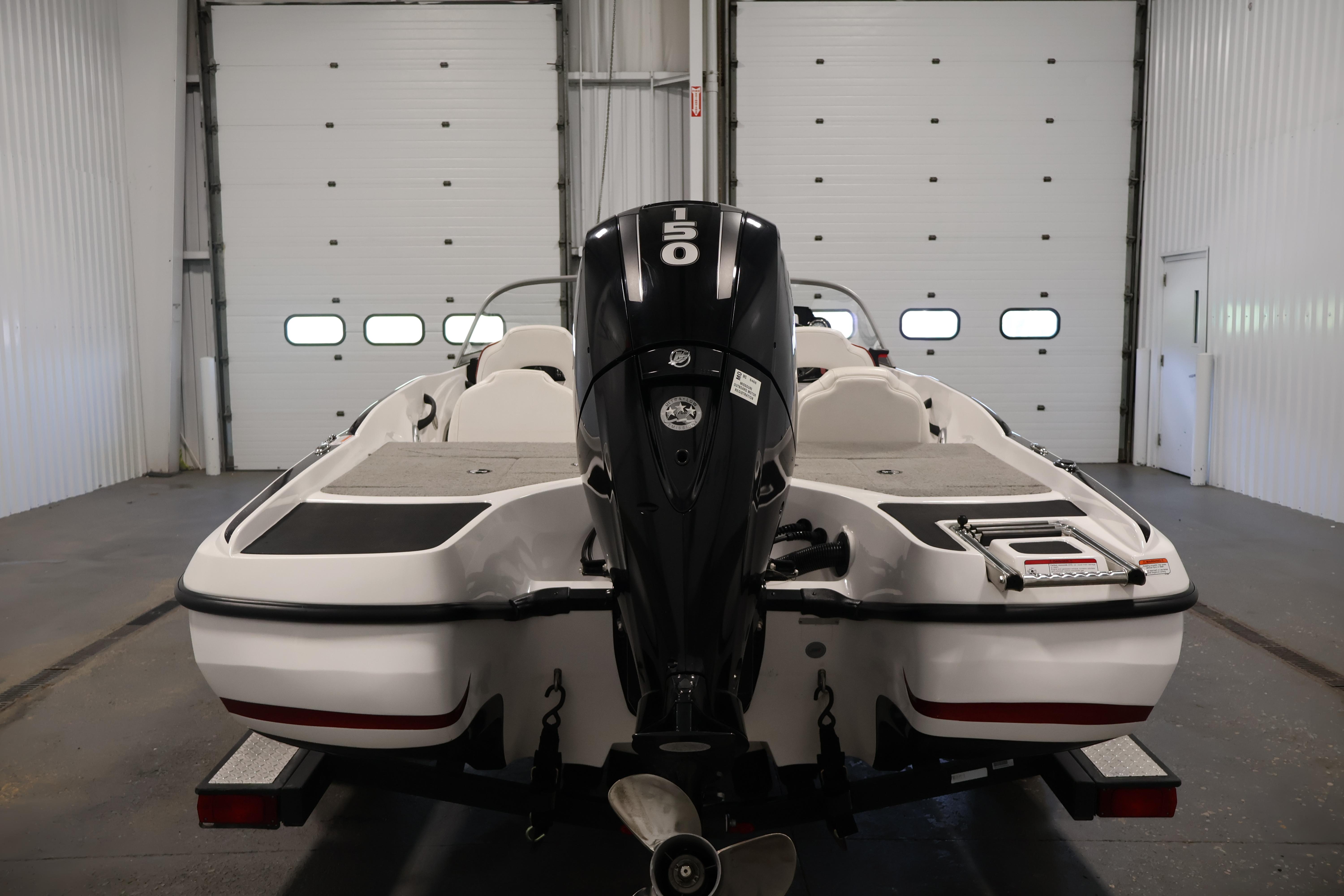2019 Nitro Z19 Sport boat with 150 HP engine in a garage setting.
