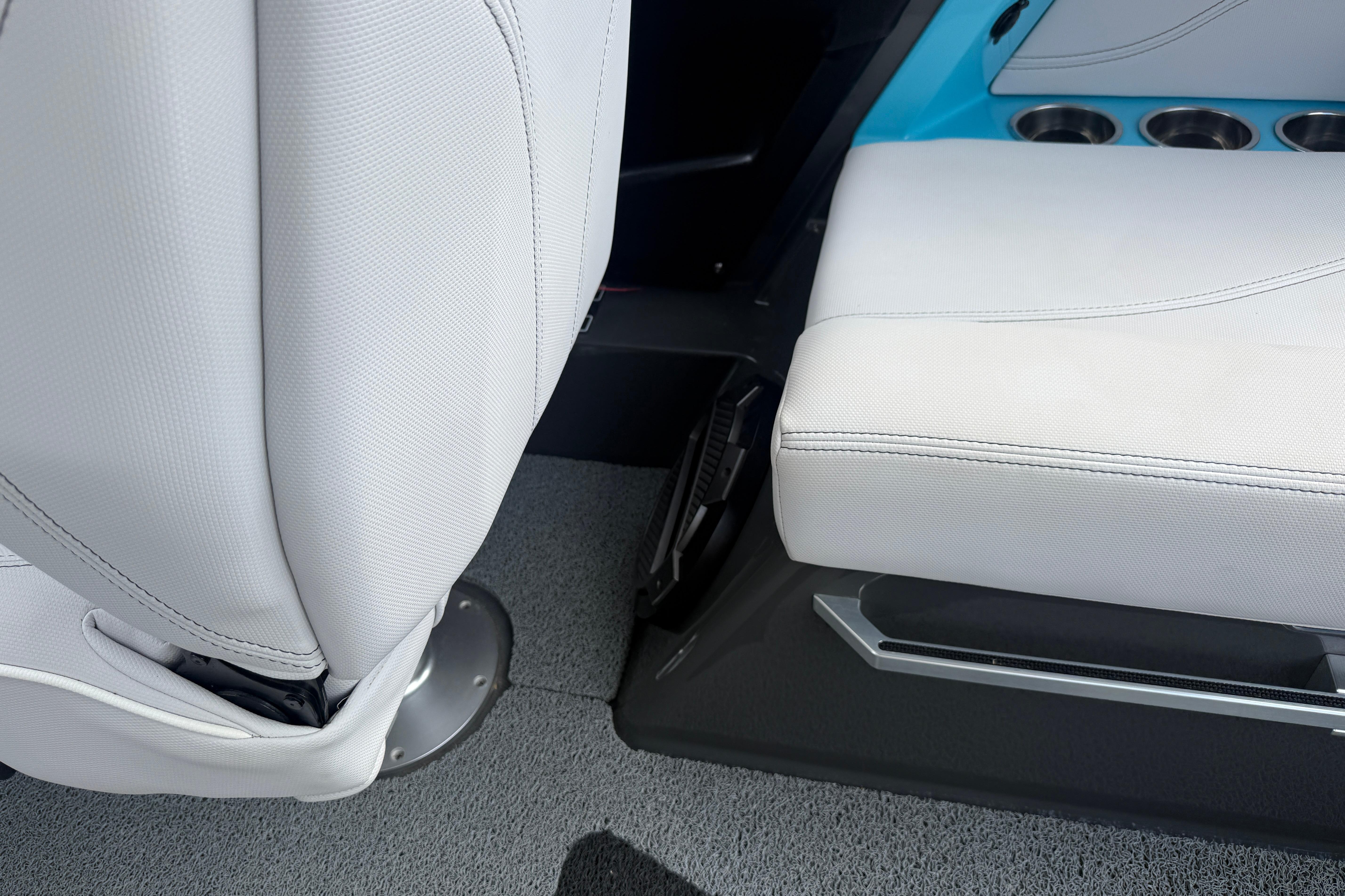 2018 MasterCraft XT21 interior seating with white upholstery and cup holders.