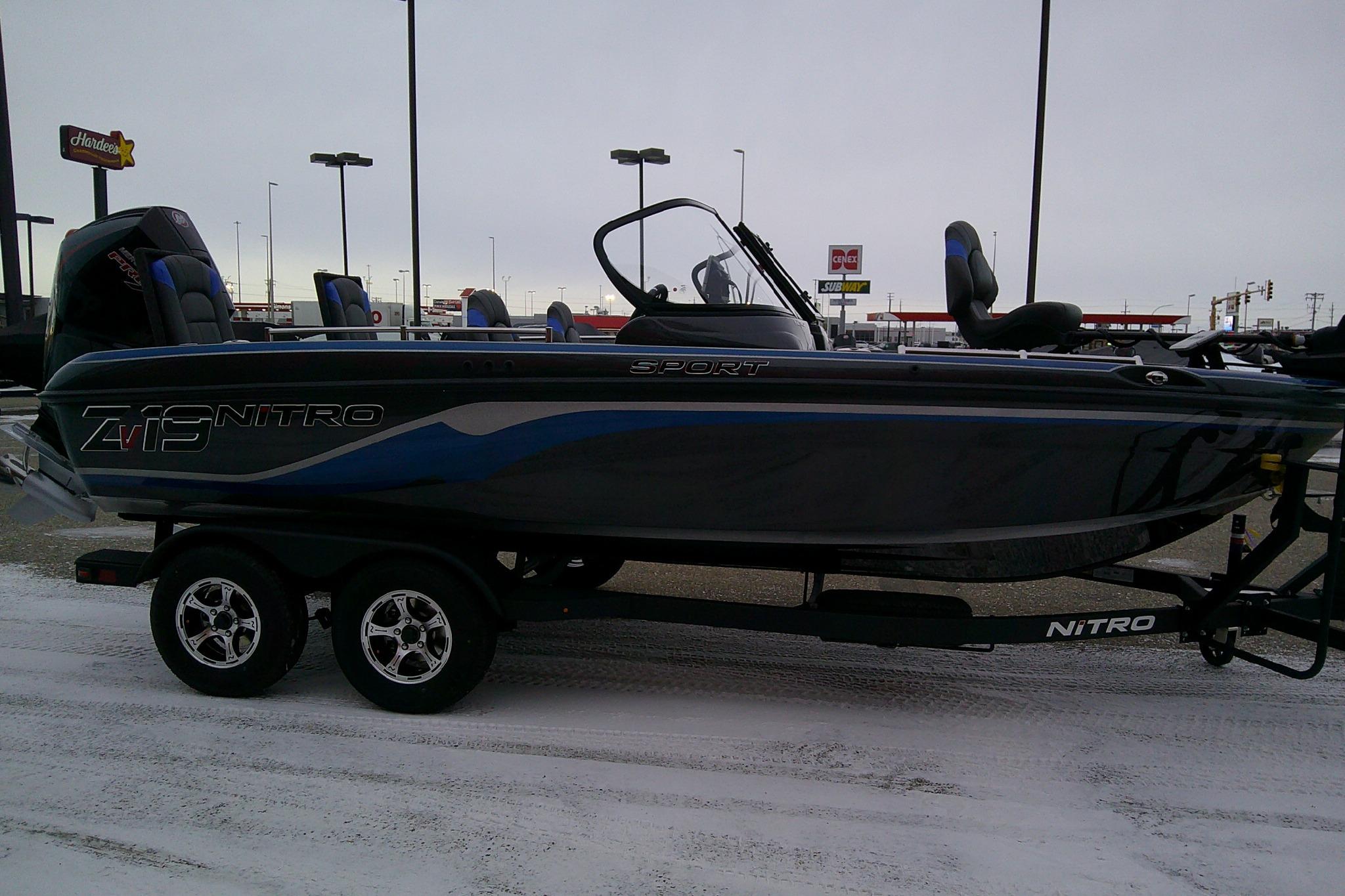 2026 Nitro ZV19 Sport Pro boat on trailer in snowy parking lot.
