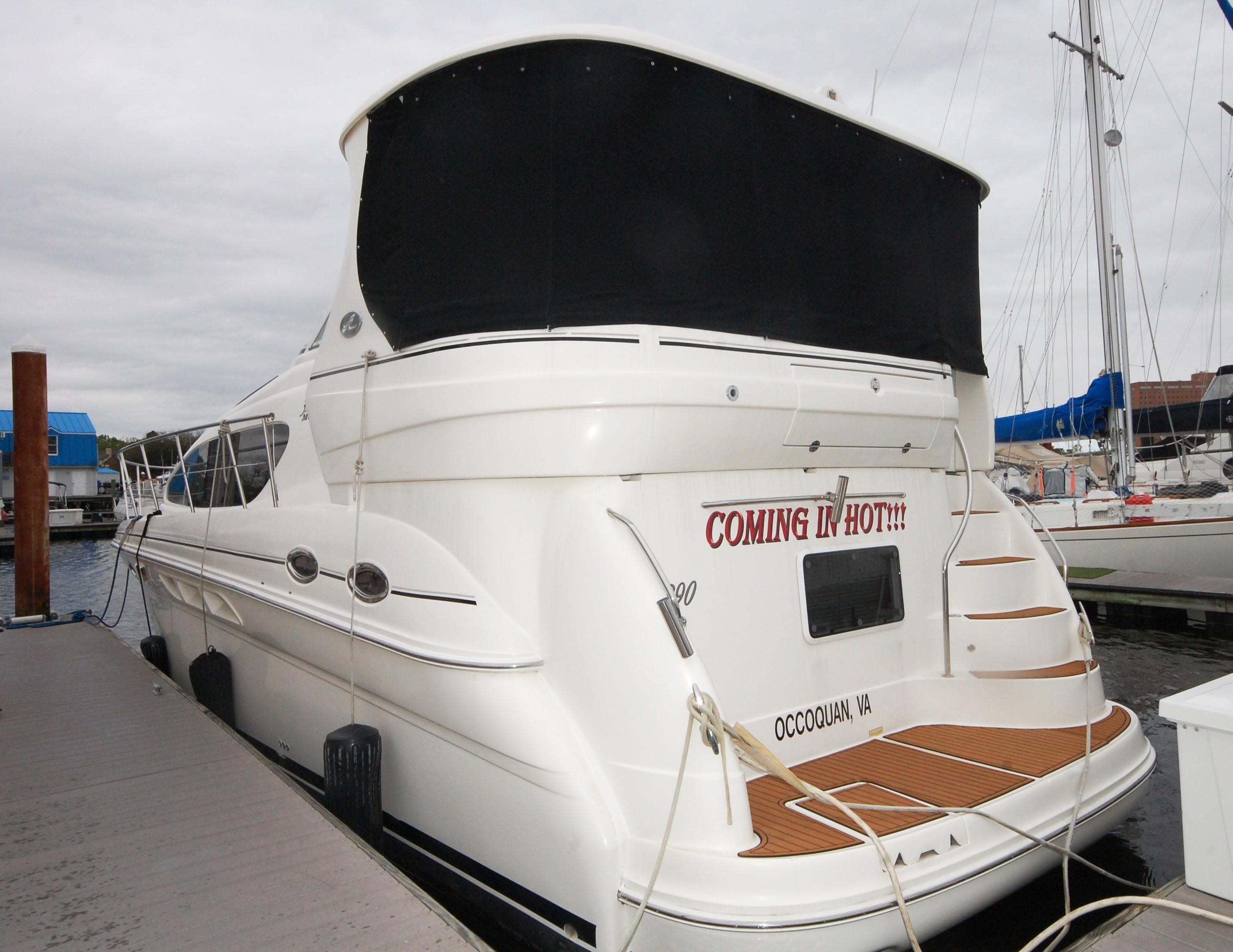 2005 Sea Ray 390 Motor Yacht docked at marina, rear view.