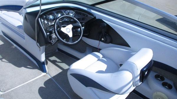 Interior of 2012 Crownline 21 SS boat with steering wheel and seating.