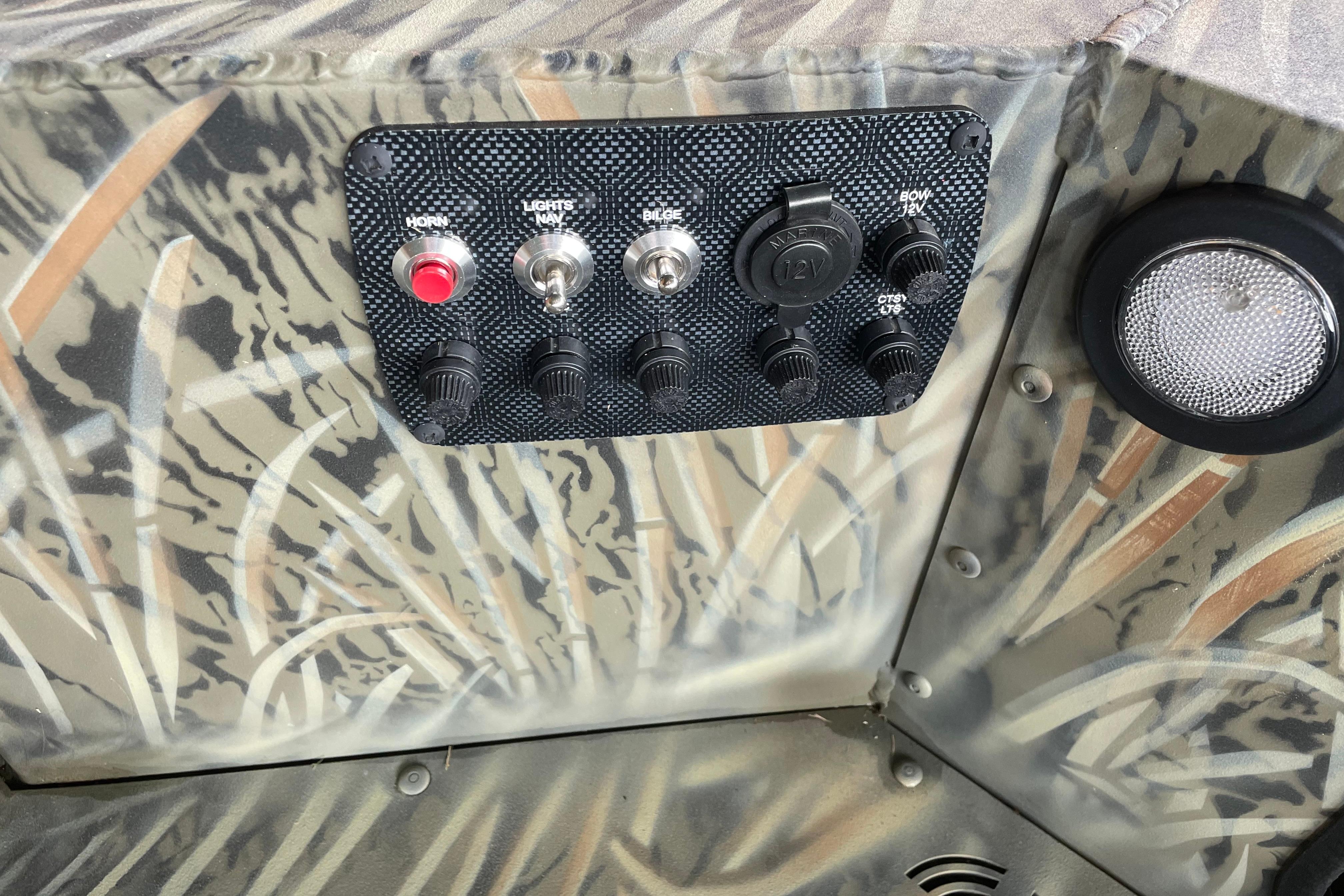 Control panel of 2026 Tracker Grizzly 1654 T Sportsman boat with camouflage design.