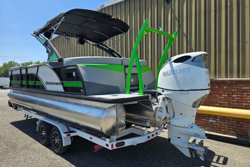 2026 Berkshire STS Arch Performance Series pontoon boat with Suzuki outboard motor on trailer.