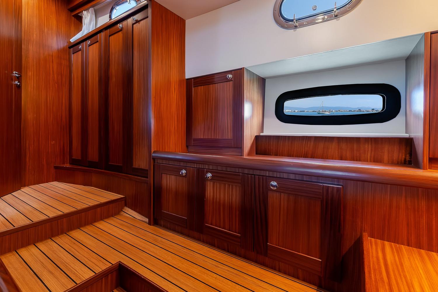 Luxurious wooden interior of 2018 Sasga Yachts Minorchino 34 cabin with window view.