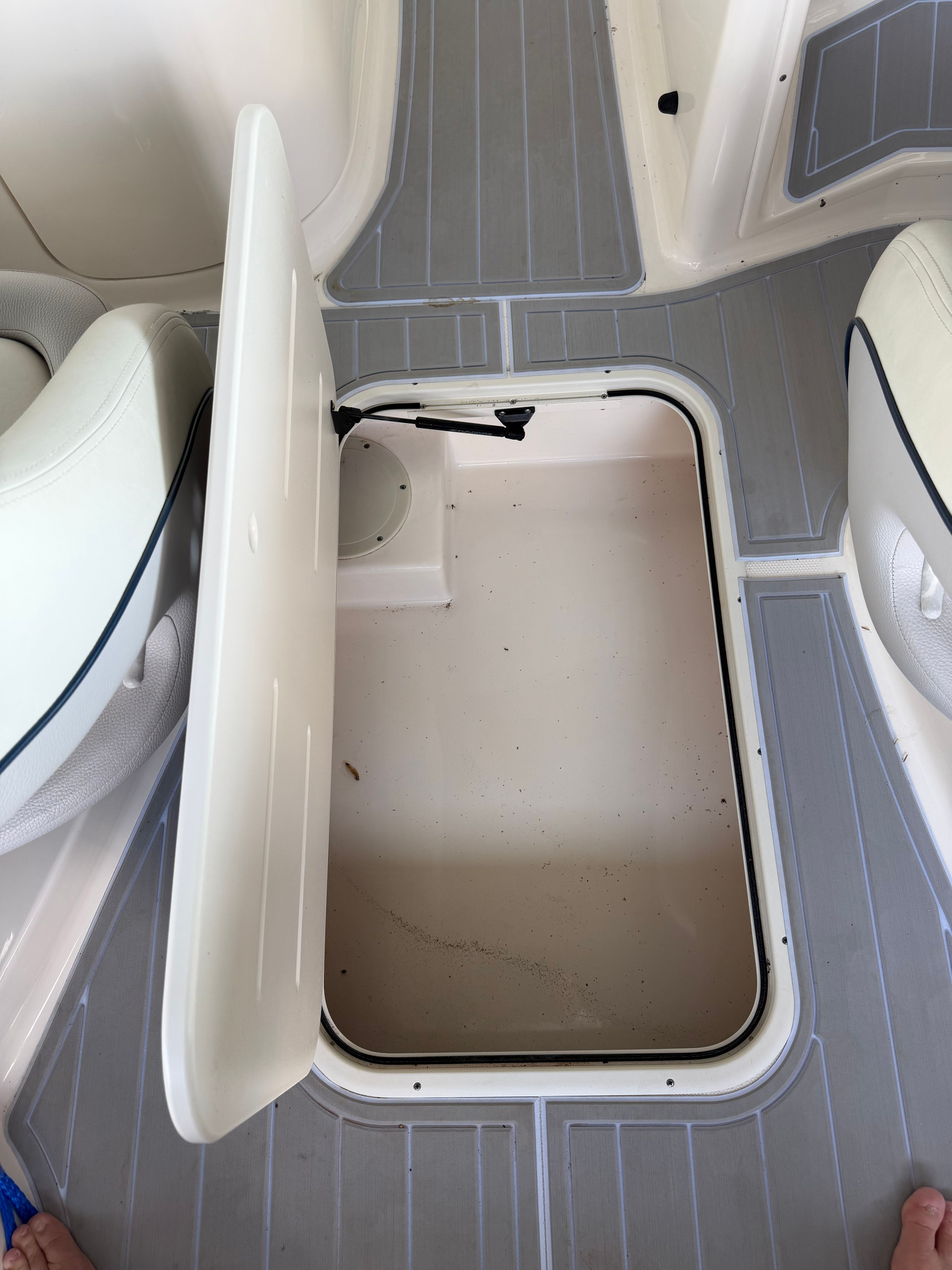 Open storage compartment on a 2010 Bryant 255 boat.