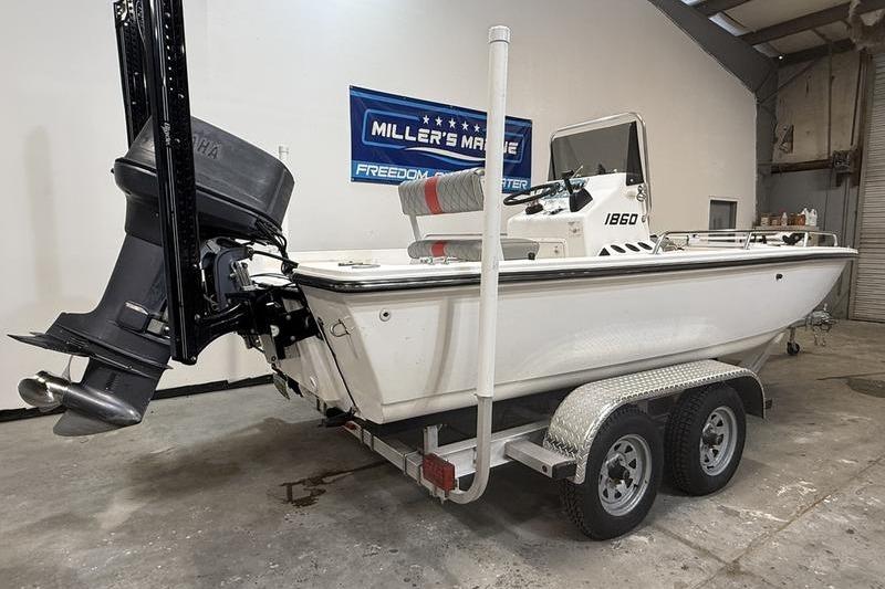 1996 Century 1800 Center Console boat on trailer in a garage setting.
