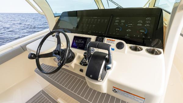 Helm of 2025 Scout 425 LXF boat with advanced controls and ocean view.