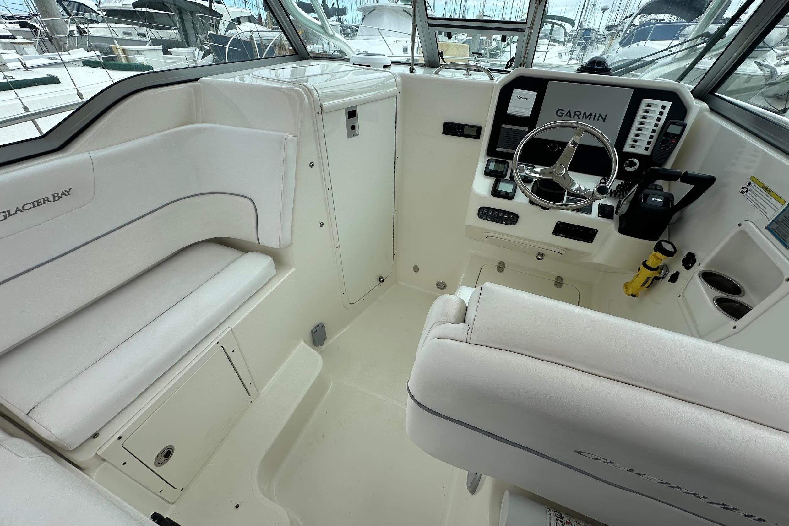 Interior of 2013 Glacier Bay 2680 Coastal Runner boat with Garmin navigation system.