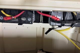 Battery compartment of 2021 Scout 215 Dorado boat with visible wiring connections.