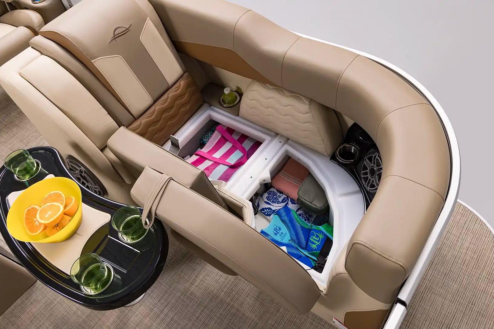 Luxurious seating and storage on 2026 SunCatcher Elite 322SR boat, featuring refreshments and accessories.