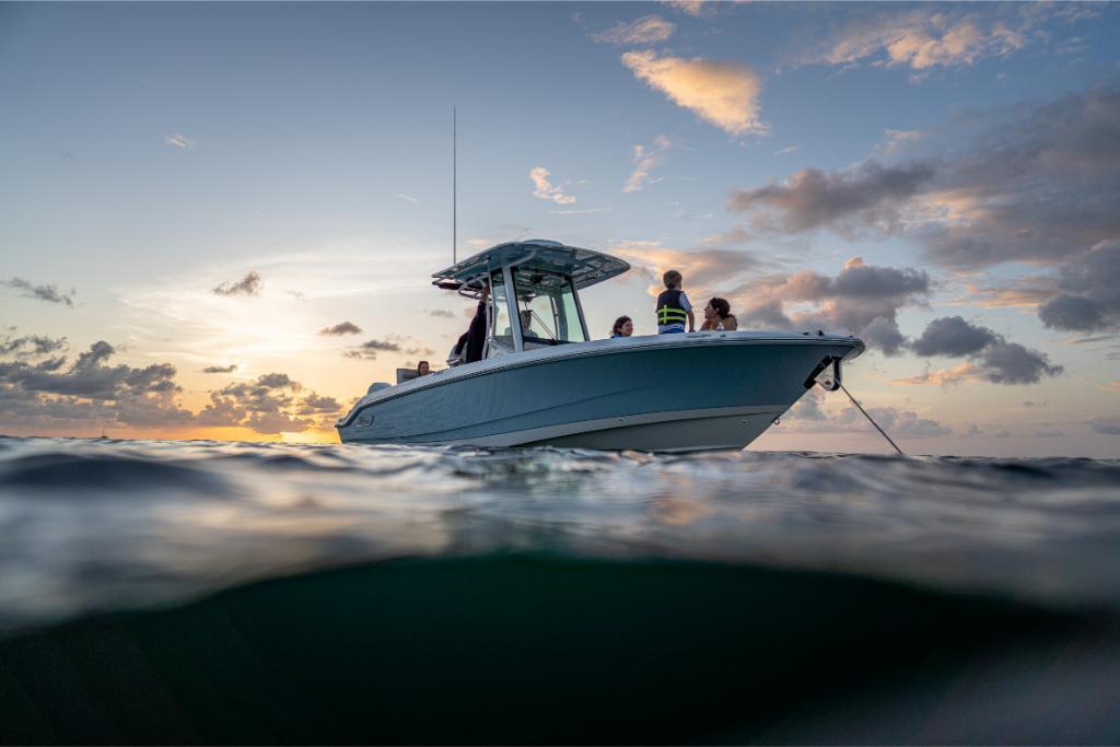 2024 Boston Whaler 280 Dauntless boat at sunset on the water.
