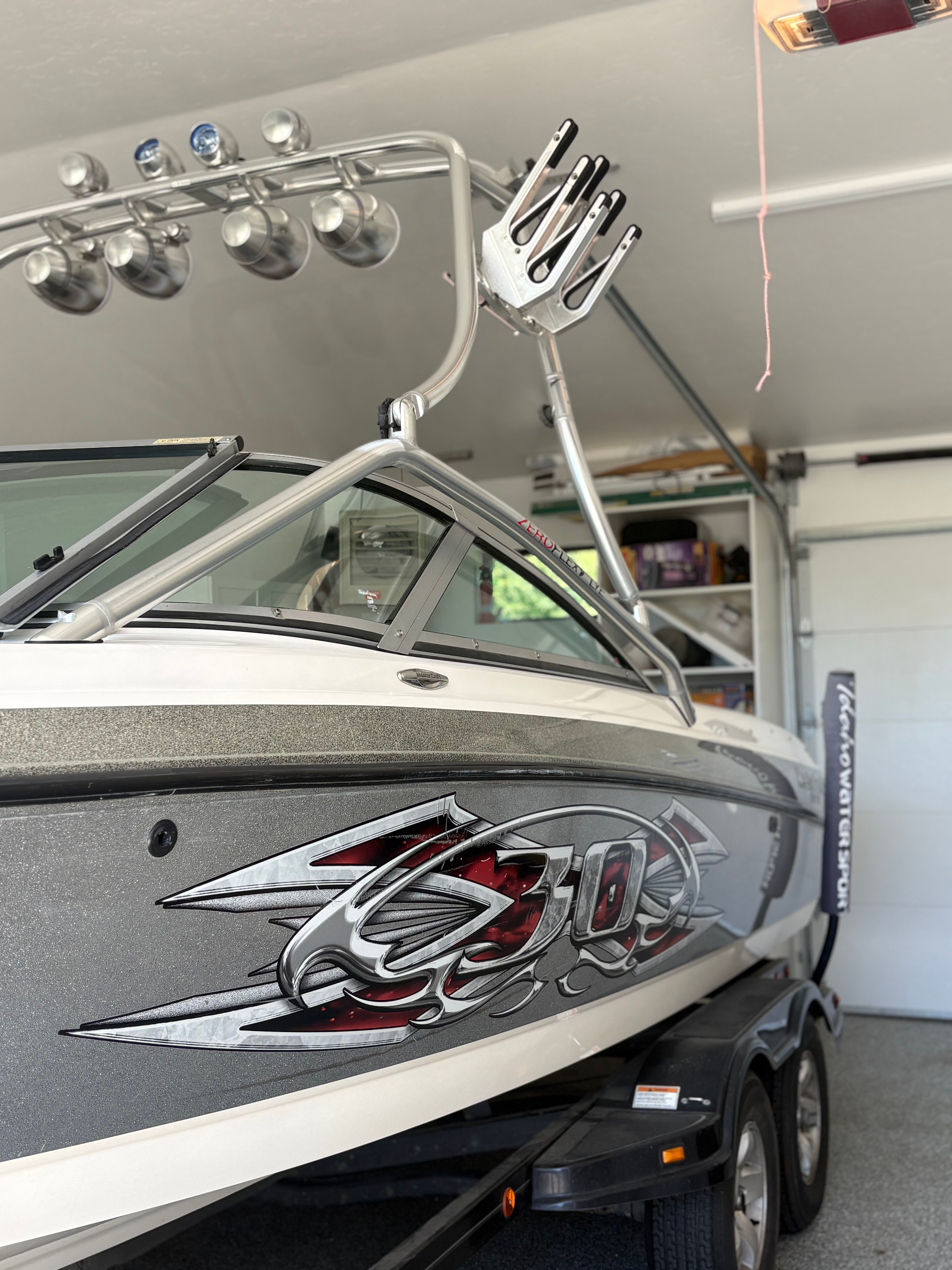 2004 MasterCraft X30 boat parked in a garage.
