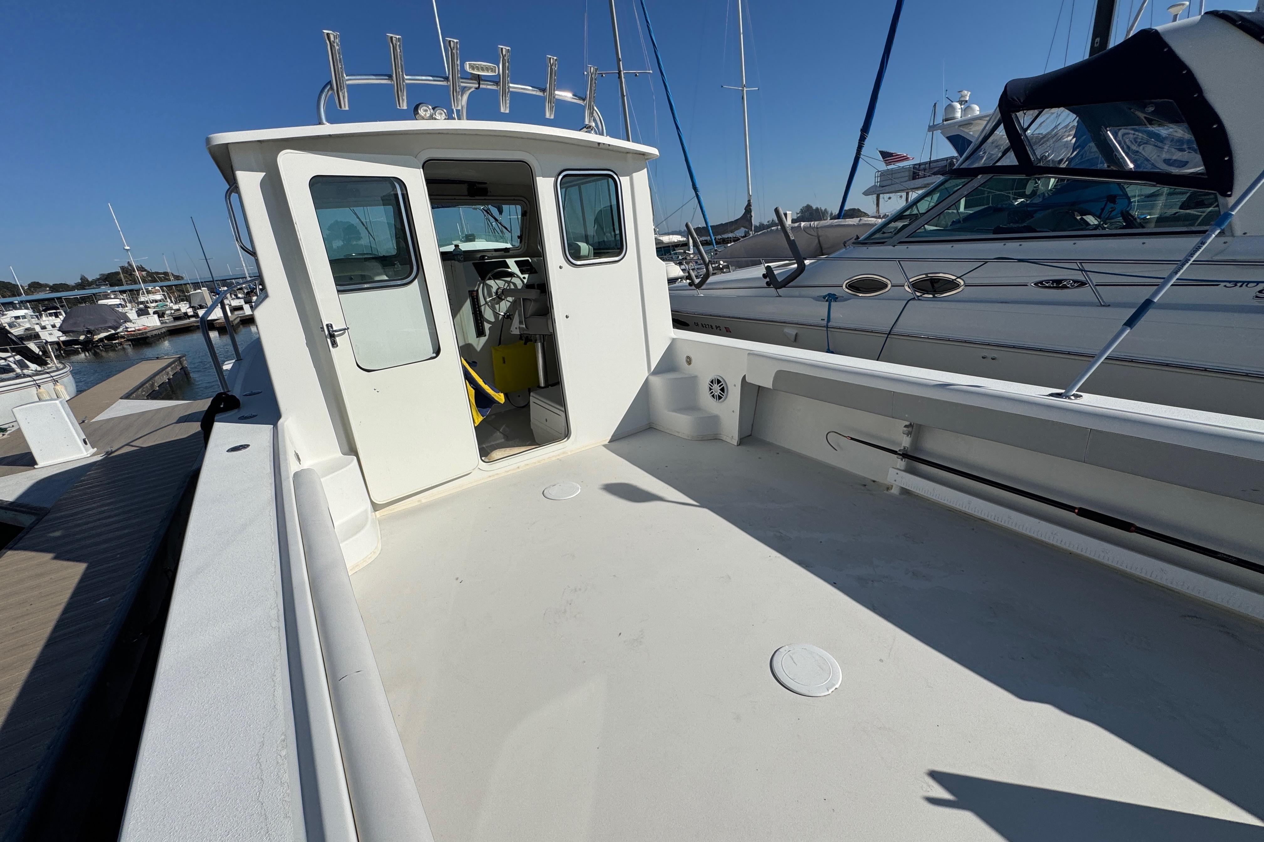 2021 Parker 2820 XLD Sport Cabin boat docked at marina under clear blue sky.