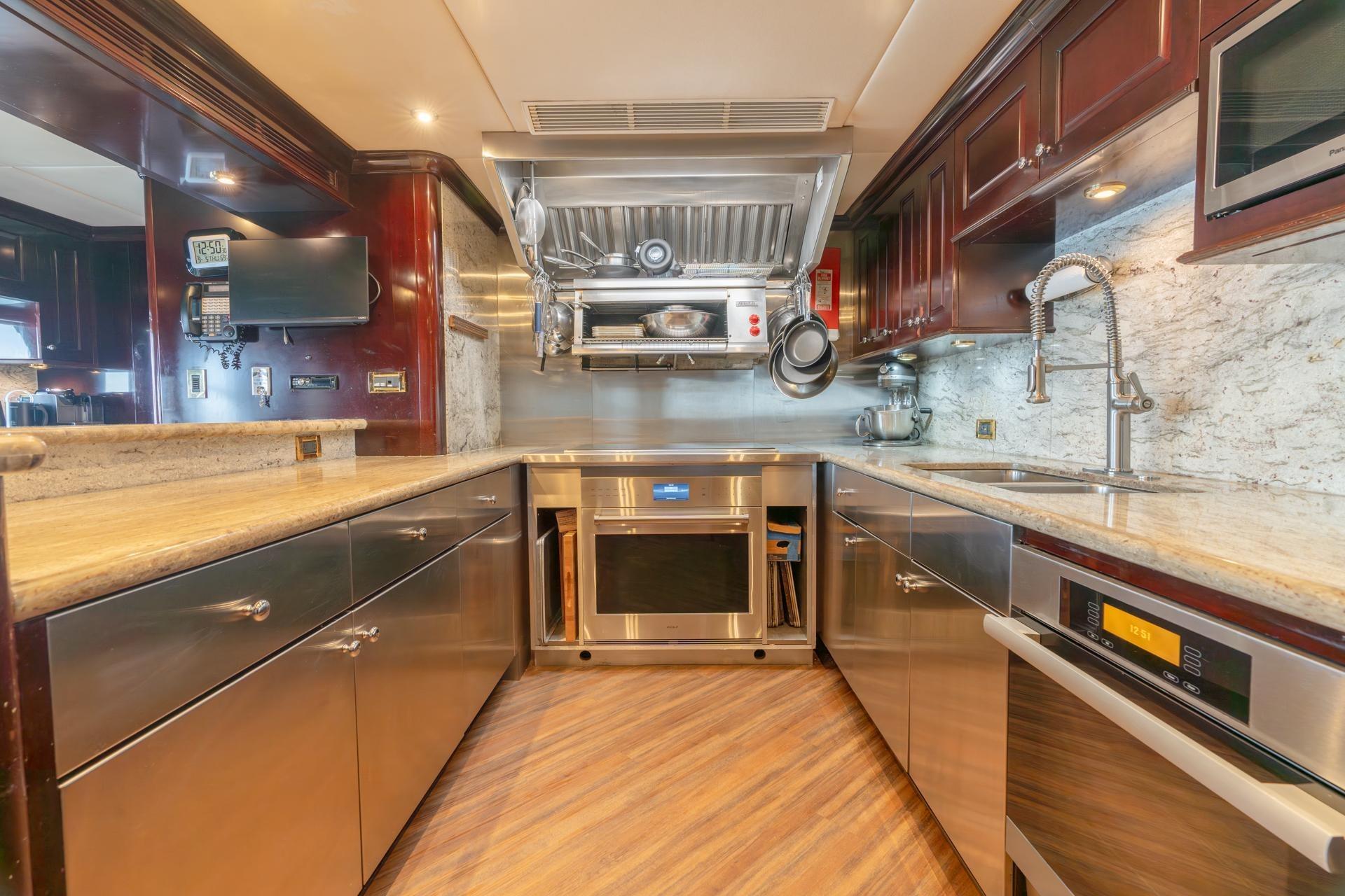 Luxurious kitchen in a 2006 Trinity Tri-Deck Motor Yacht with modern appliances.