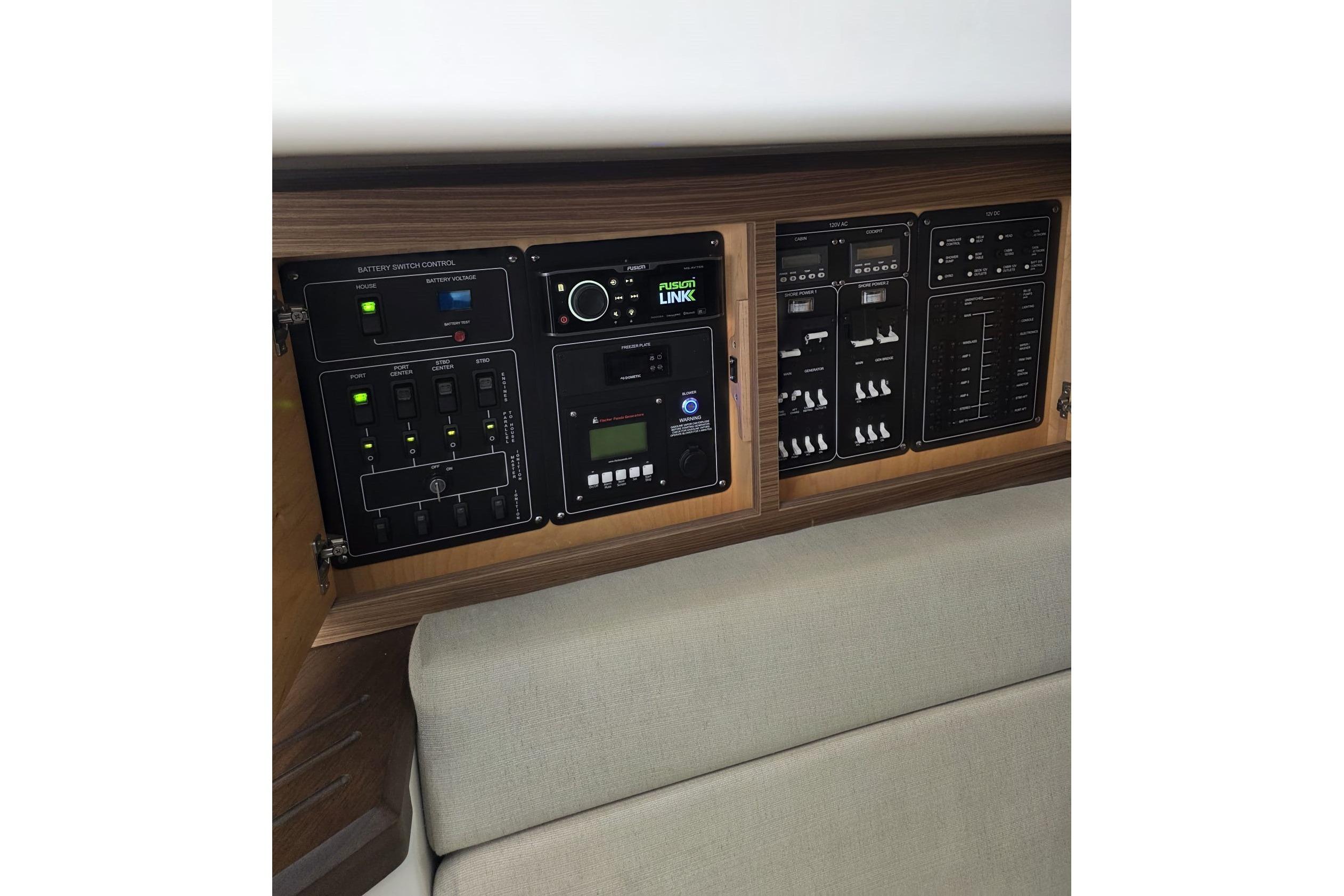 Control panel of a 2020 Boston Whaler 420 Outrage boat, featuring various switches and displays.