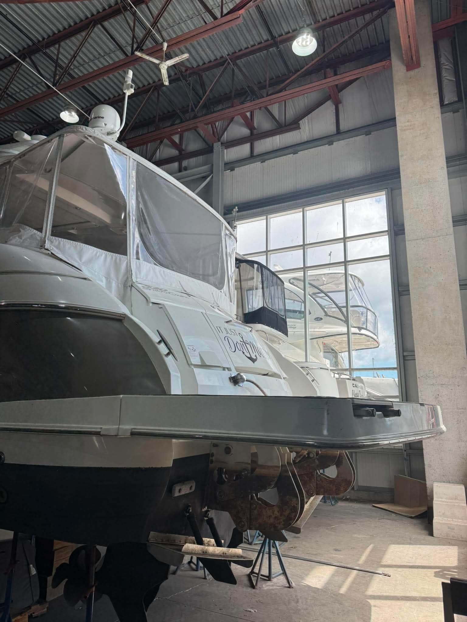A 2009 Cruisers Yachts 520 Sports Coupe is in a warehouse for maintenance.