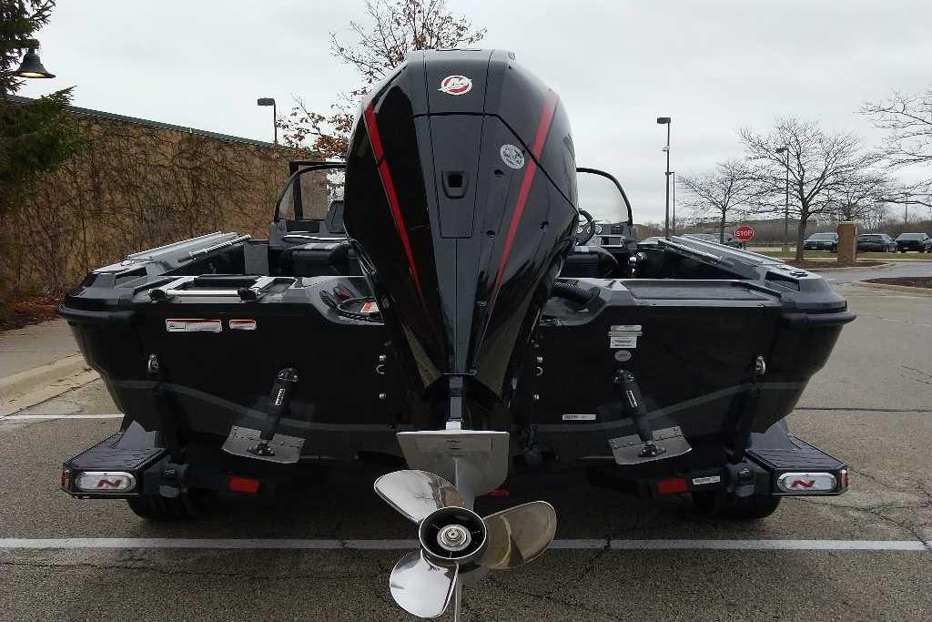 2026 Nitro ZV20 Pro boat, rear view with powerful outboard motor in a parking lot.