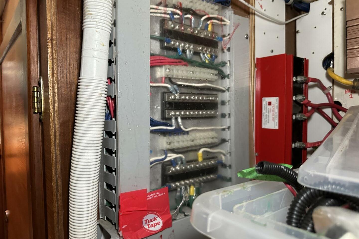 Electrical panel with wiring inside a 1979 Hughes 3910 boat.