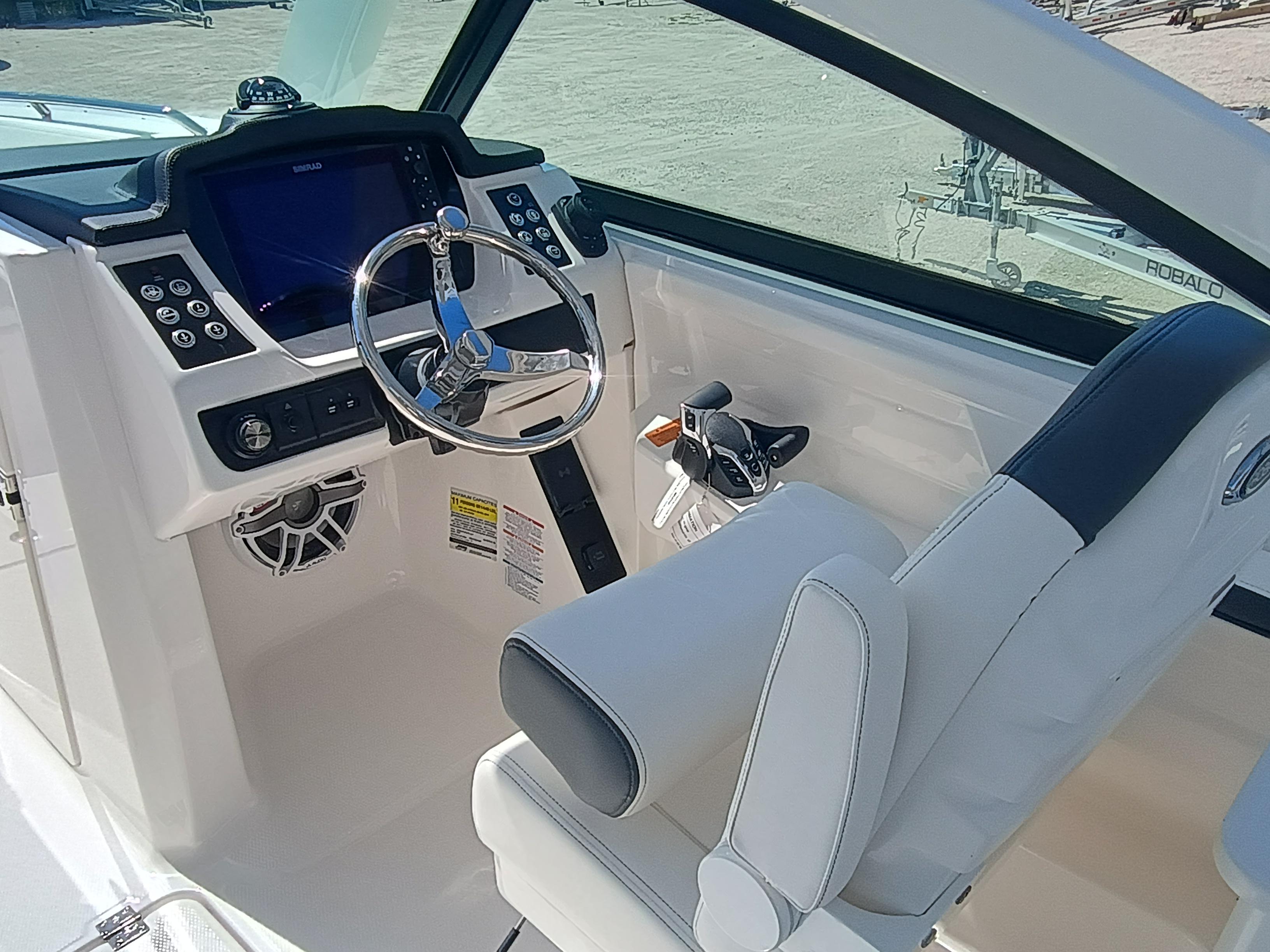 2025 Robalo R257 Dual Console boat interior with steering wheel and control panel.
