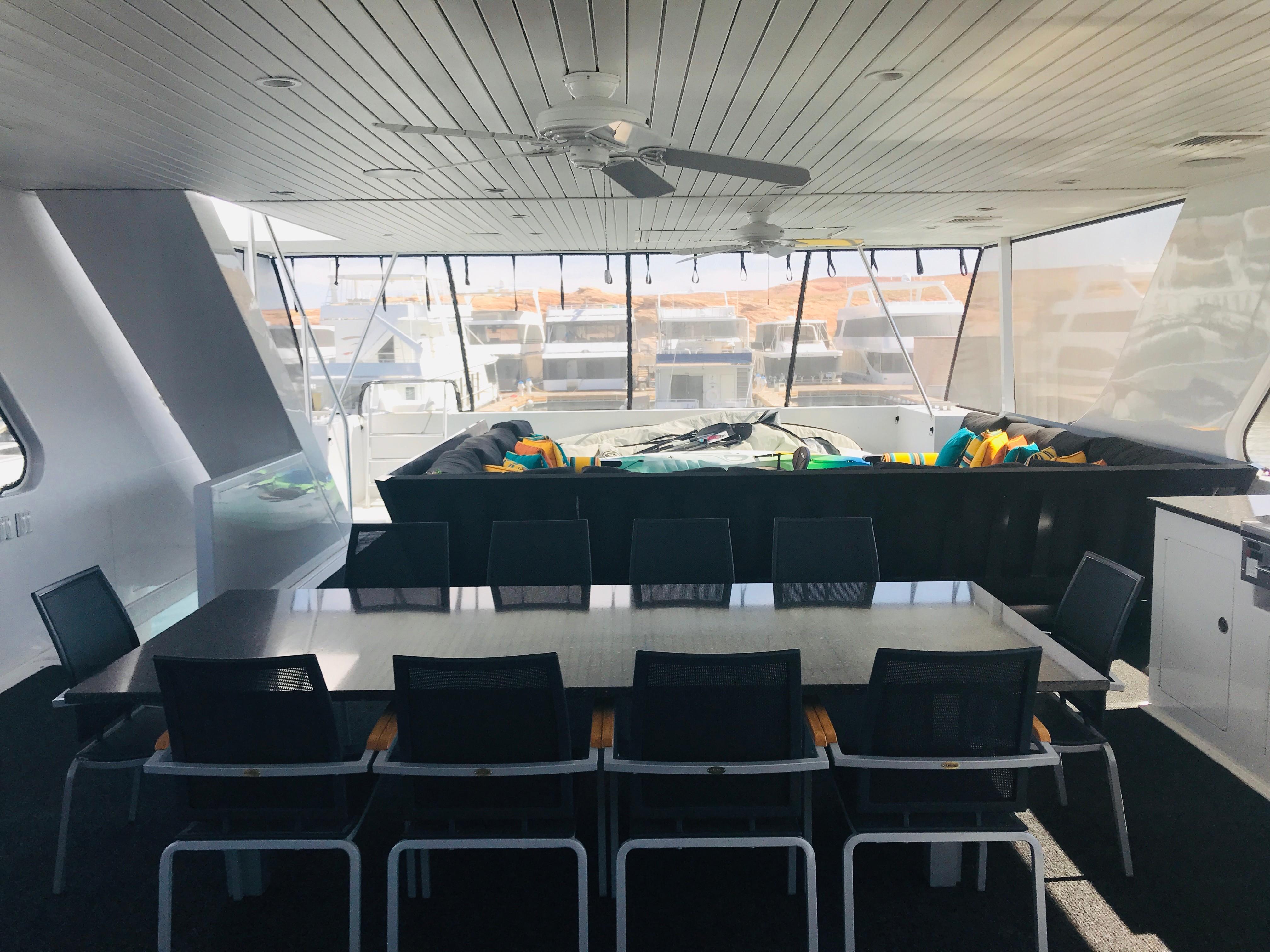 Luxurious interior of 2018 Adonia Adonis Trip 3 yacht with dining area and large windows.