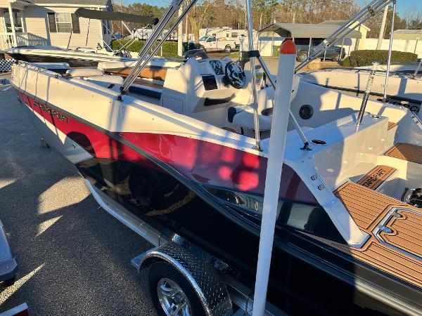 2024 Starcraft SVX 191 boat with red and black exterior, parked on a trailer.