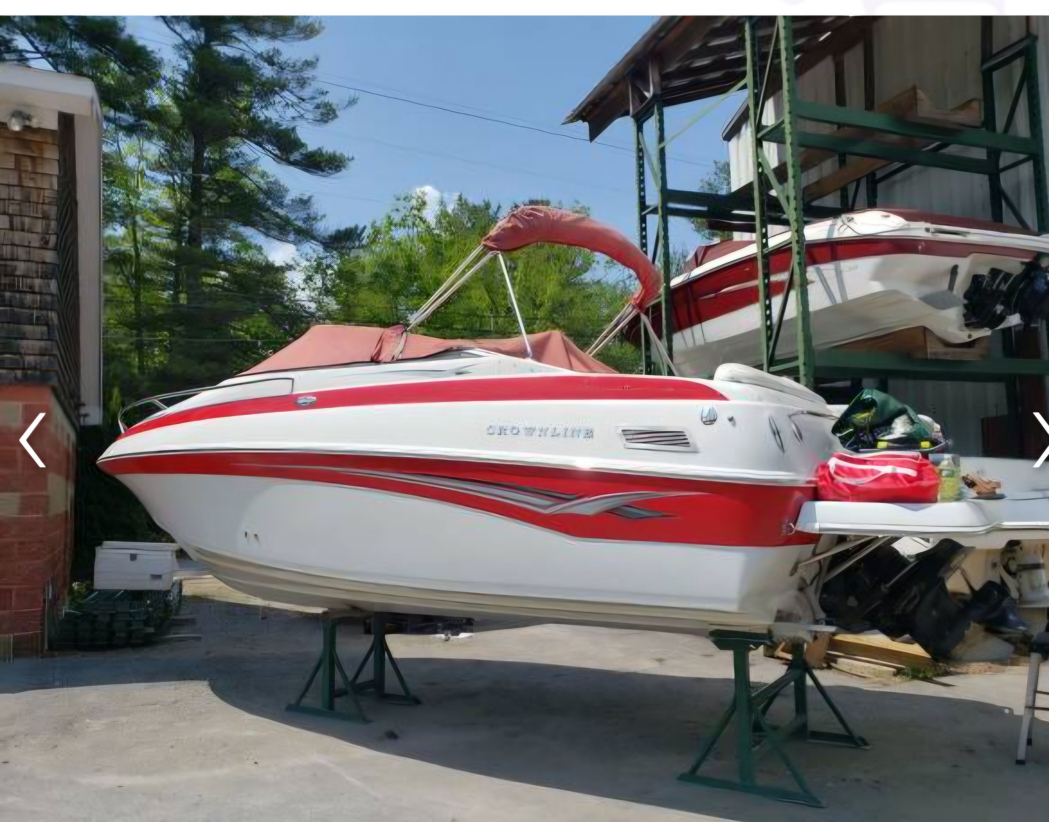 2003 Crownline 215CCR boat on stands outdoors.