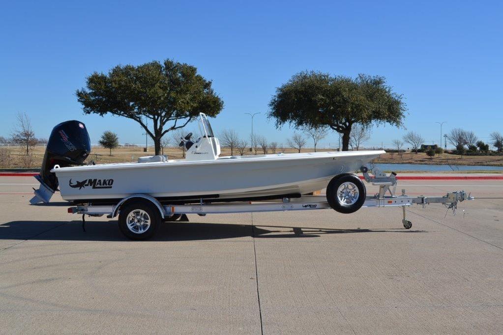 2026 Mako 18 Pro Skiff boat on trailer, parked outdoors.