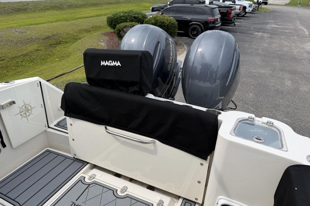 2023 Stingray 273 CC boat with dual Yamaha engines and Magma grill cover.