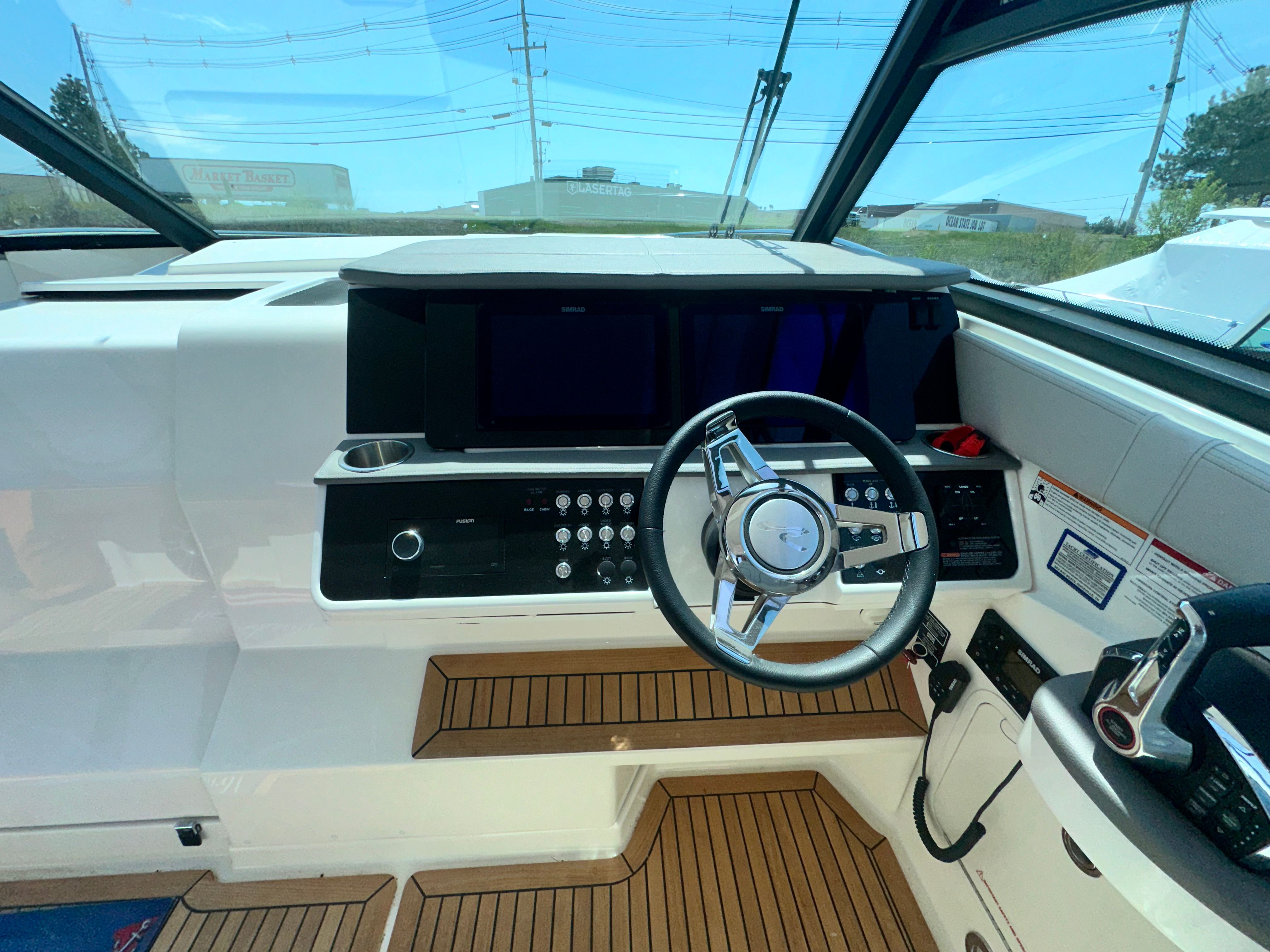 Cockpit of 2024 Sea Ray Sundancer 320 Outboard with modern steering and instruments.