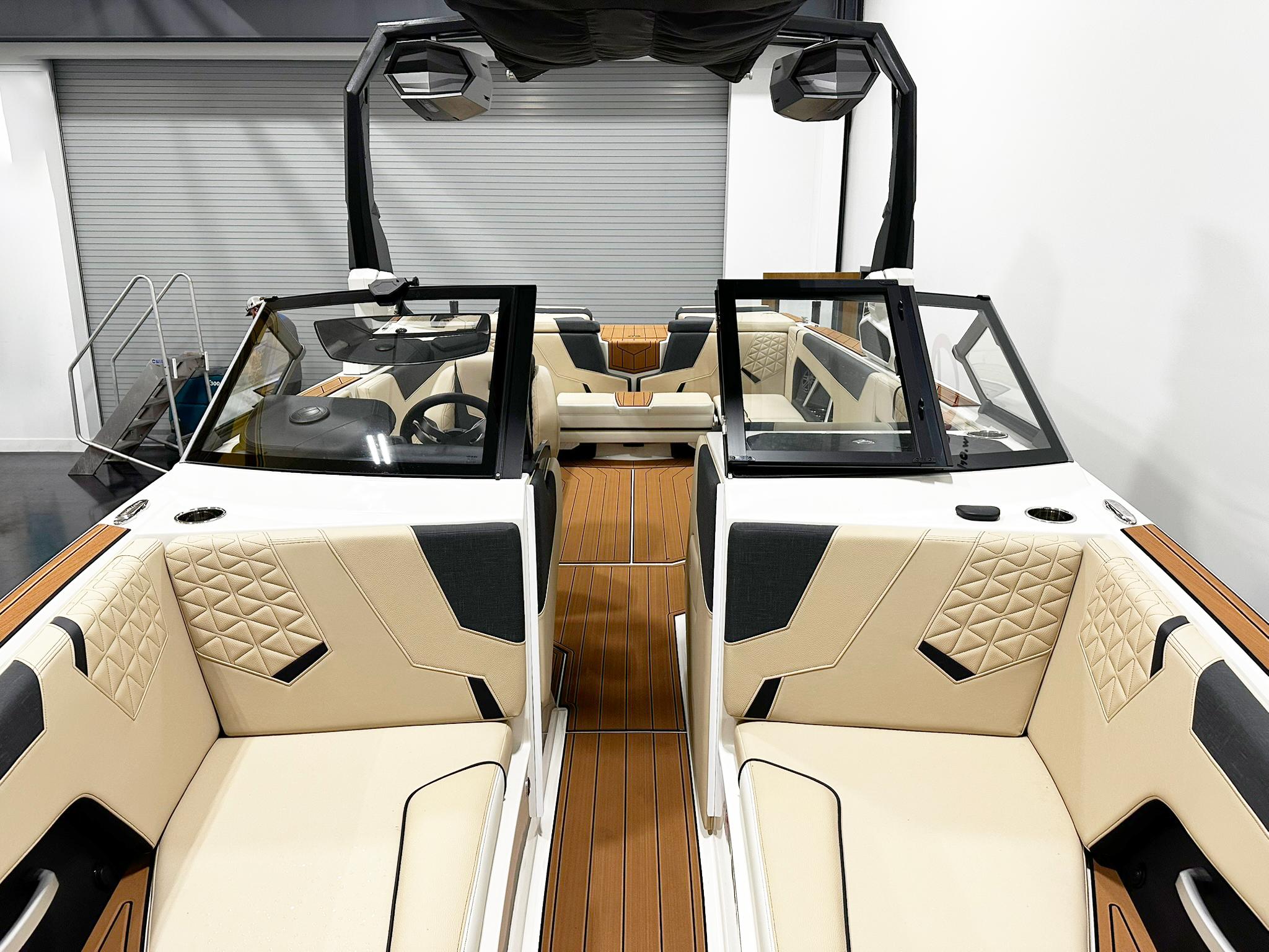 2026 Nautique GS24 boat interior with beige and black seating, modern design.