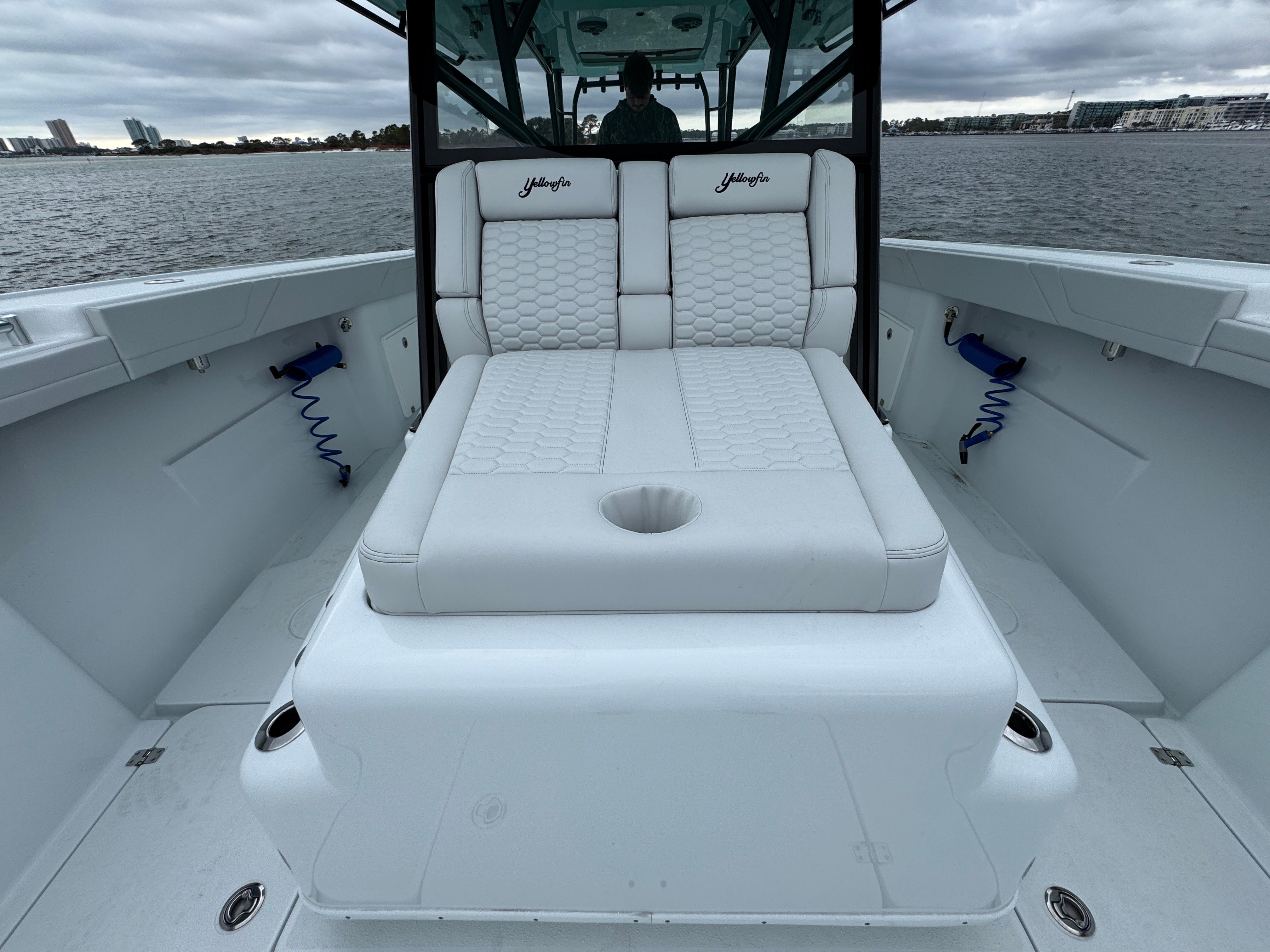 2023 Yellowfin 42 Offshore boat with white cushioned seating on deck.
