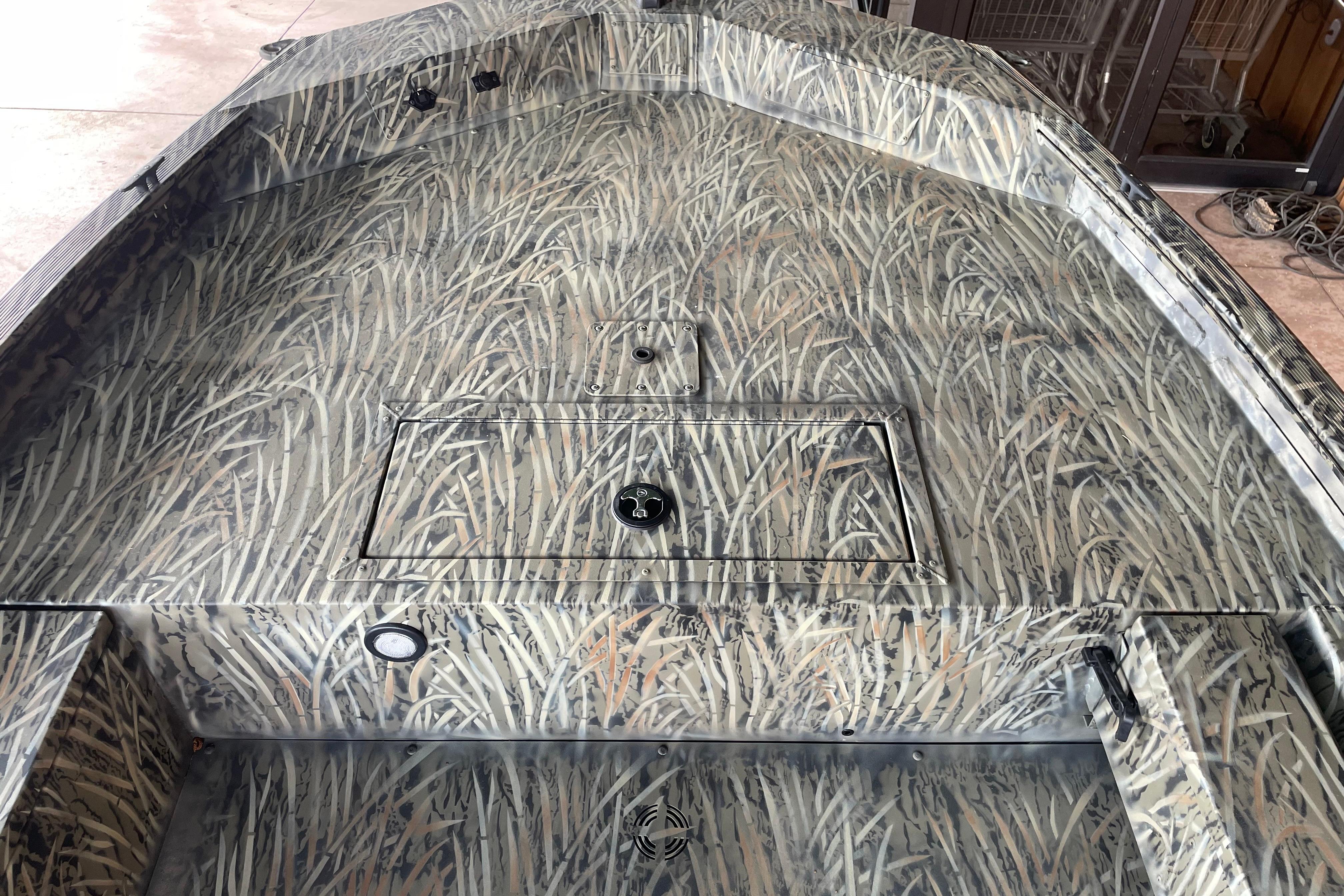 2026 Tracker Grizzly 1654 T Sportsman boat with camouflage interior design.
