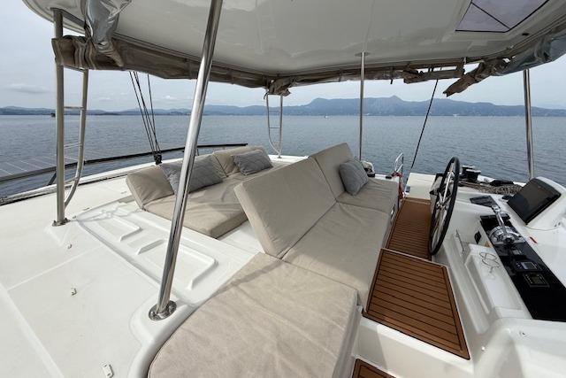 Luxurious Lagoon 46 catamaran deck with seating, 2022 model, overlooking serene waters.
