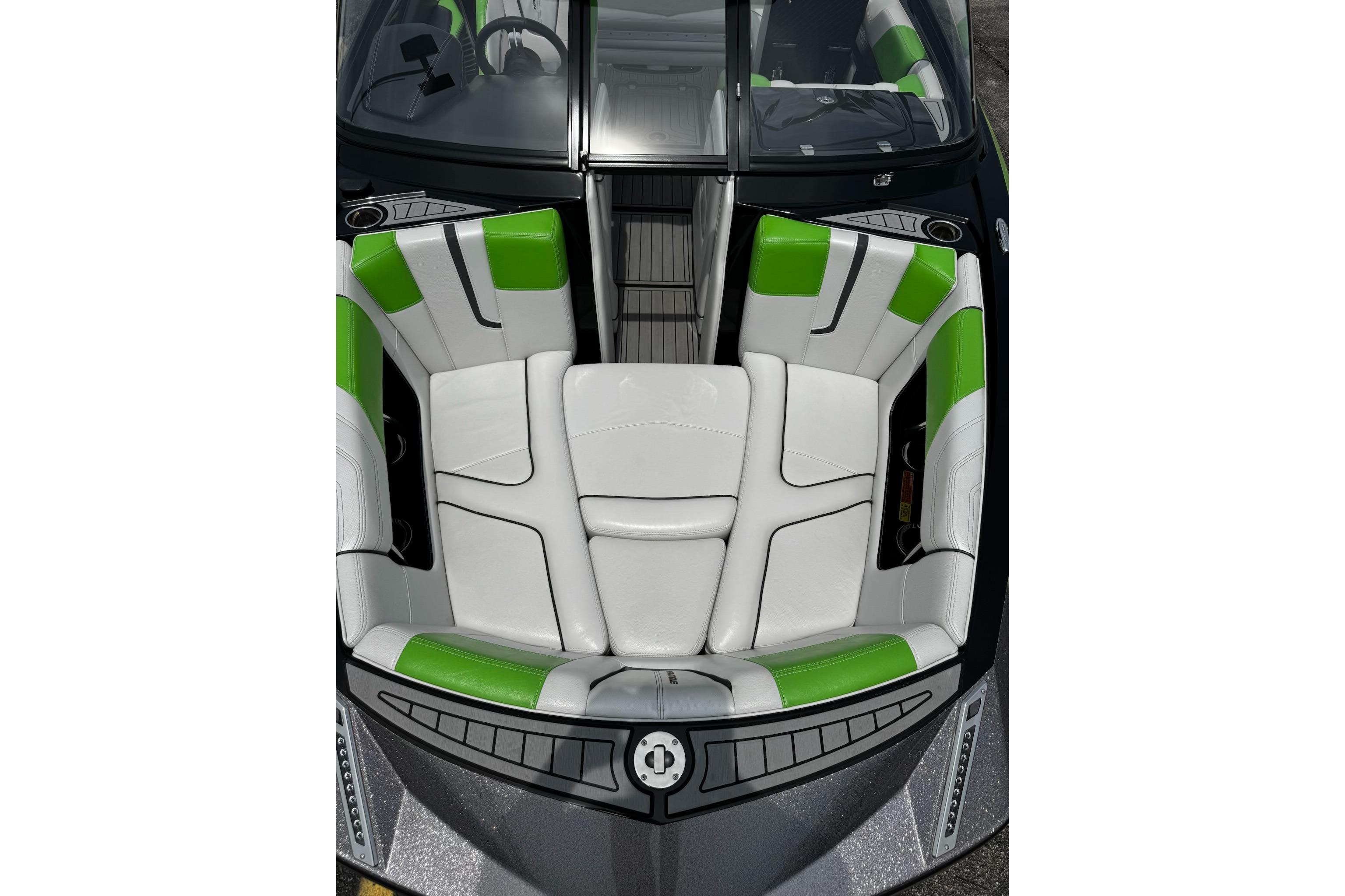 2014 Nautique Super Air Nautique G21 boat interior with green and white seating.
