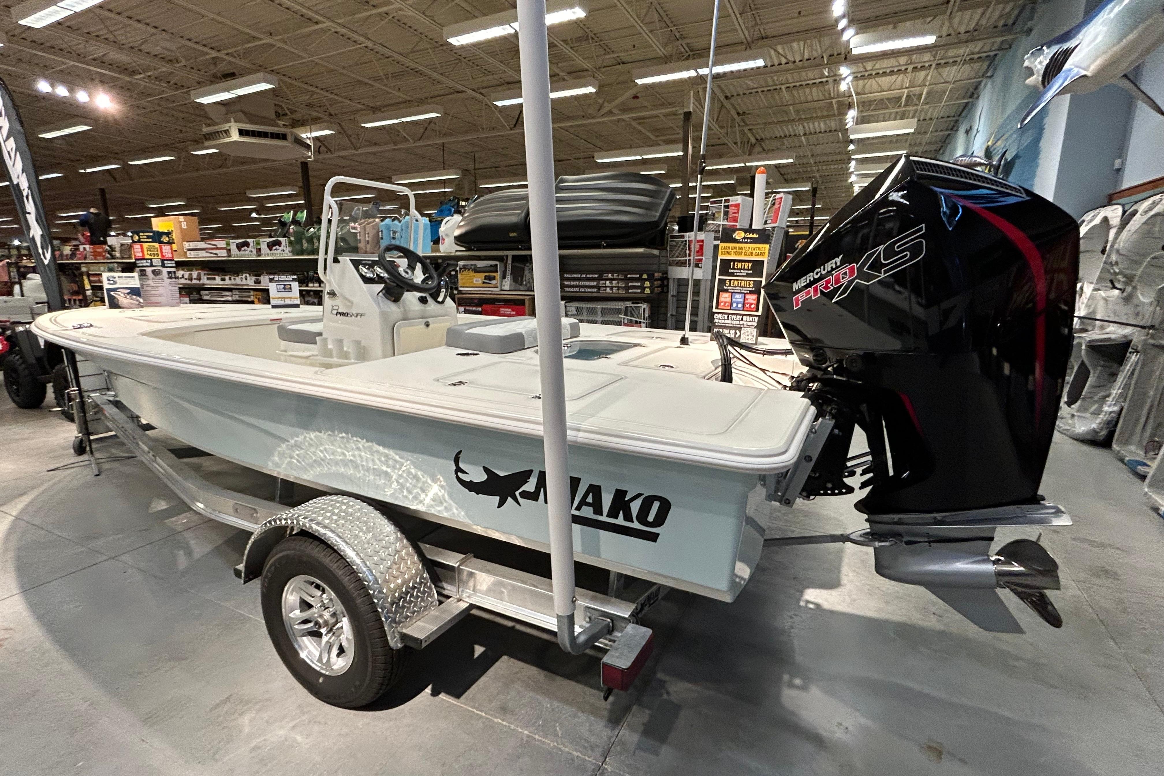 2026 Mako 18 Pro Skiff boat with Mercury Pro XS engine in showroom.