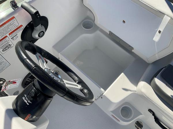 2025 Tahoe T18 boat steering wheel and storage compartment.