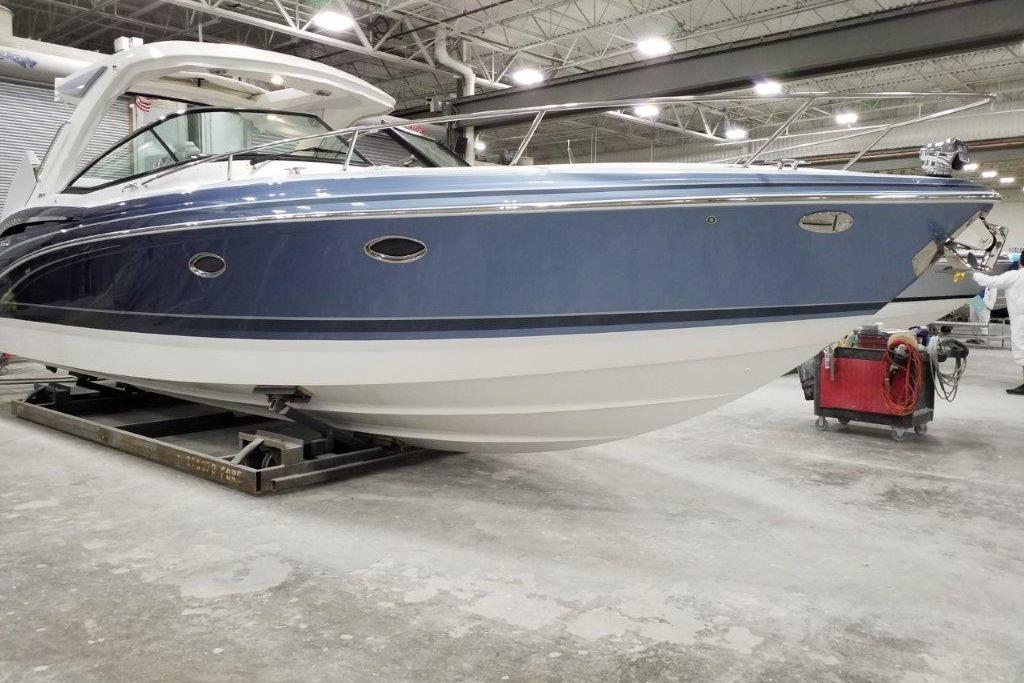 2021 Formula 350 Sun Sport boat in a workshop, showcasing sleek design and blue hull.