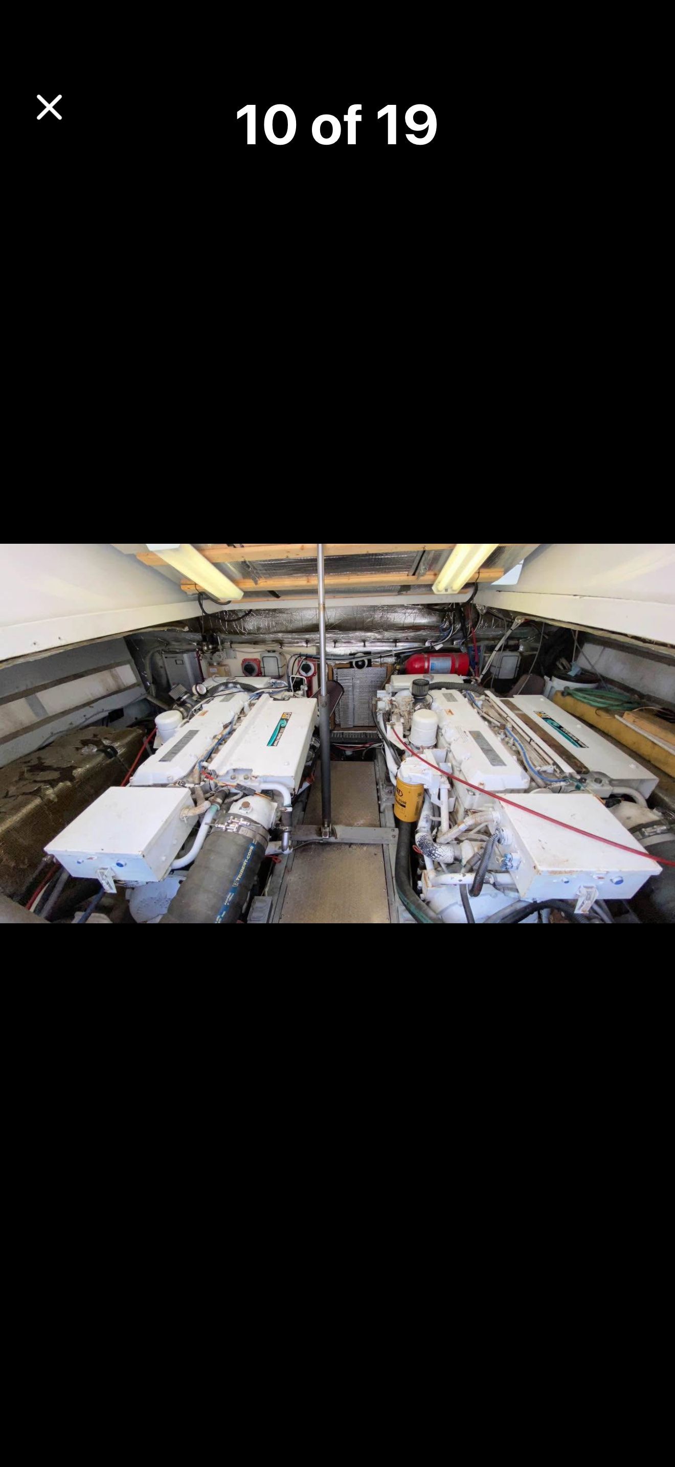 The engine room of a 1999 Luhrs Sx36 with two large engines.