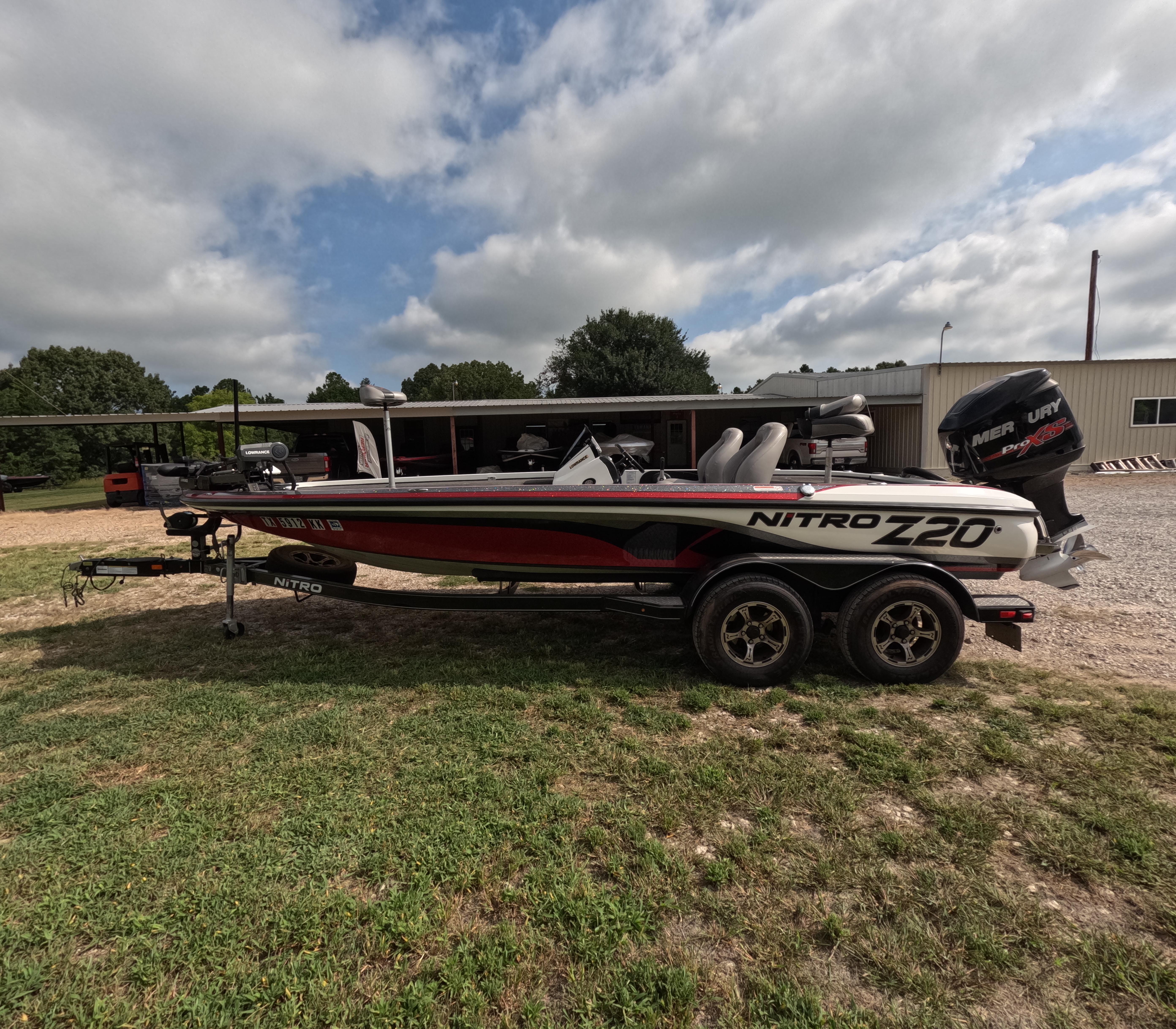 2016 Nitro Z20 boat with Mercury engine on trailer, parked outdoors under cloudy sky.