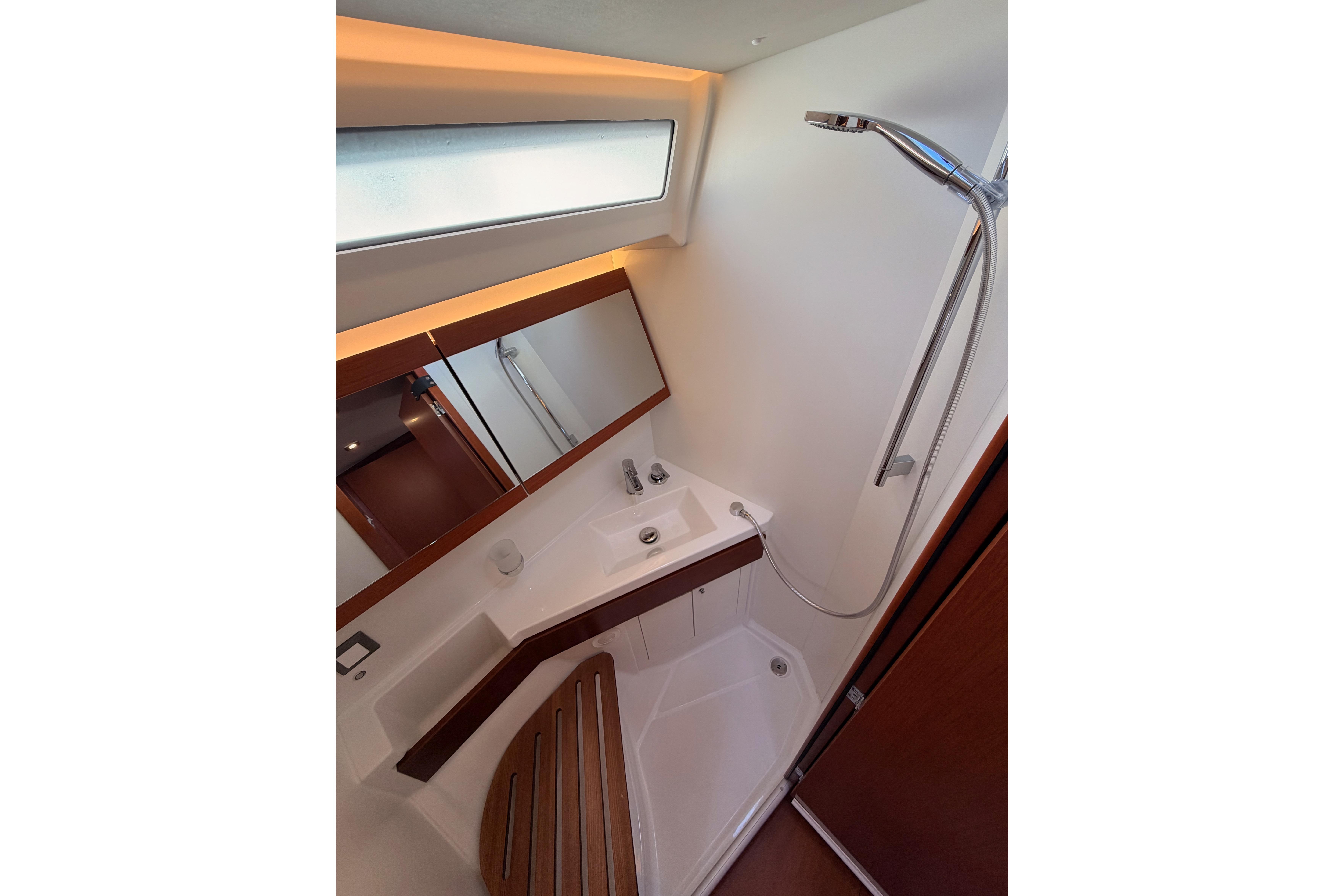 Modern bathroom interior on 2020 Beneteau Oceanis 46.1 yacht, featuring sleek shower and mirror.