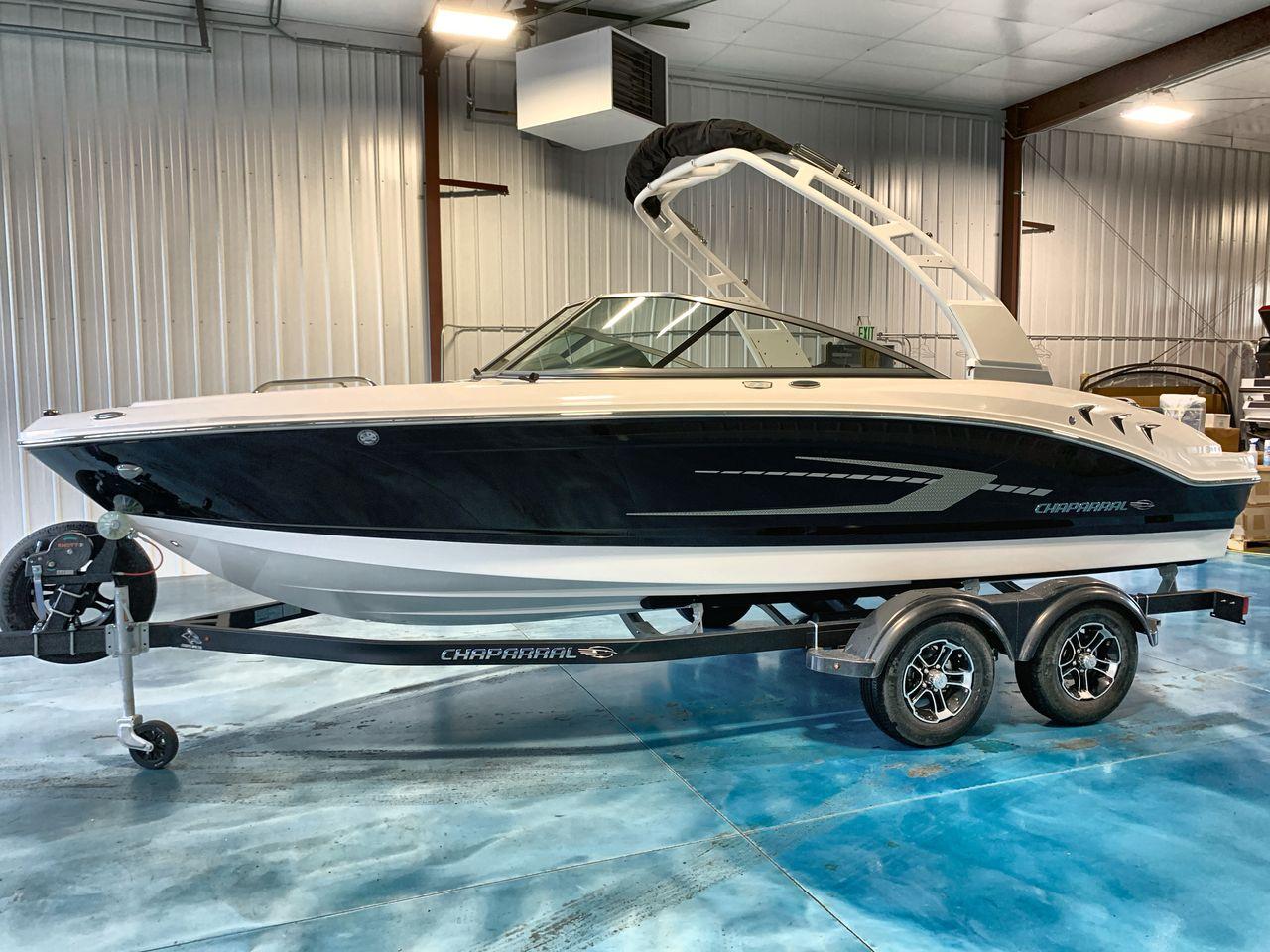 2025 Chaparral 21 SSi boat on trailer in indoor showroom.