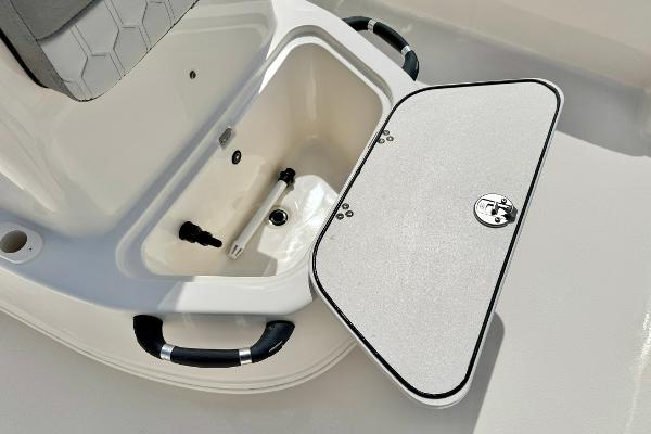 2025 Carolina Skiff 21 LS boat storage compartment with open lid and handles.