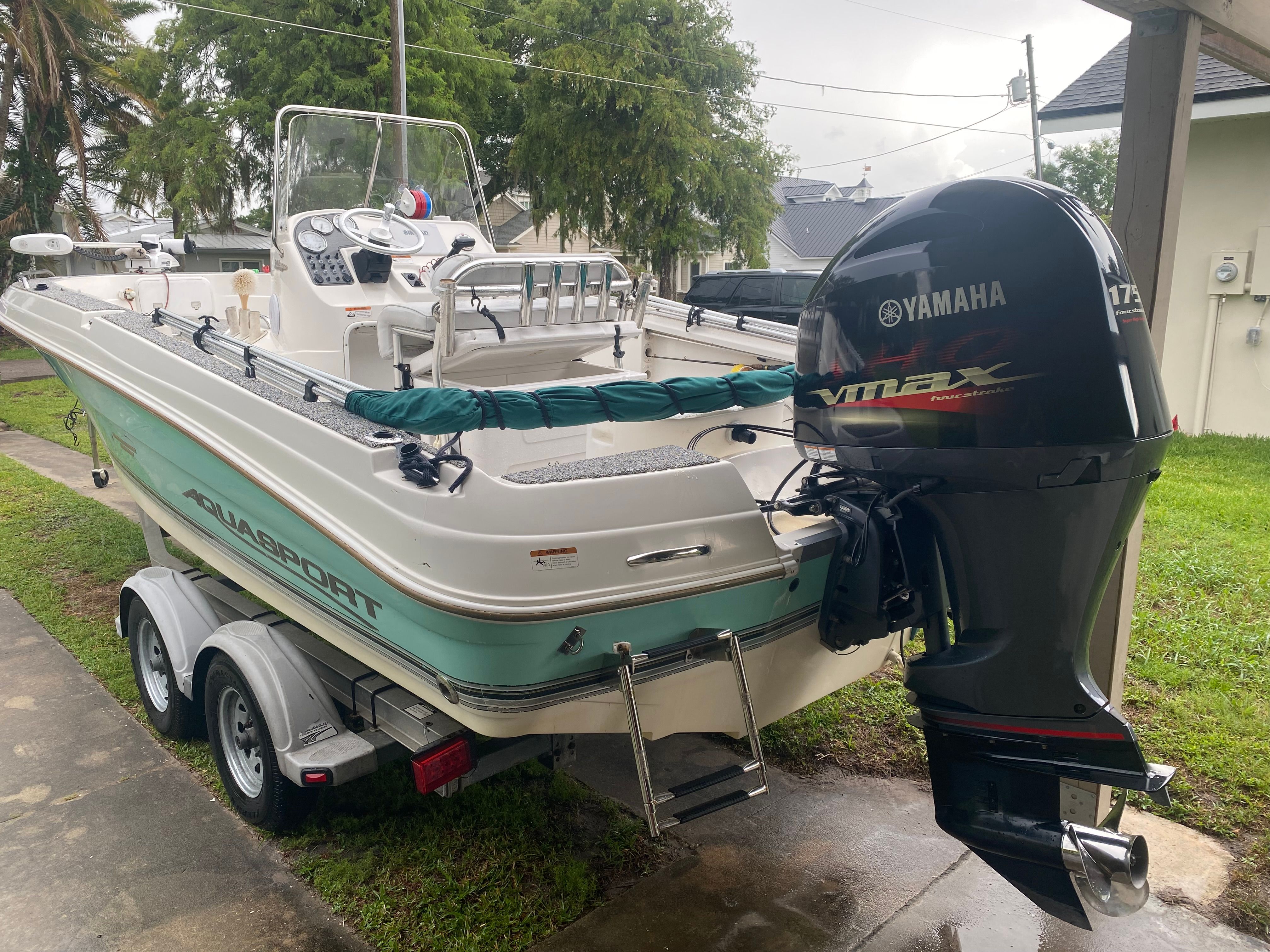 A 2003 Aquasport 201 Osprey boat on a trailer, featuring a Yamaha outboard motor.