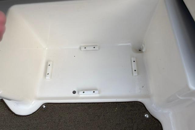 Storage compartment of a 2017 Searay SPX210 boat, featuring a clean, white interior.
