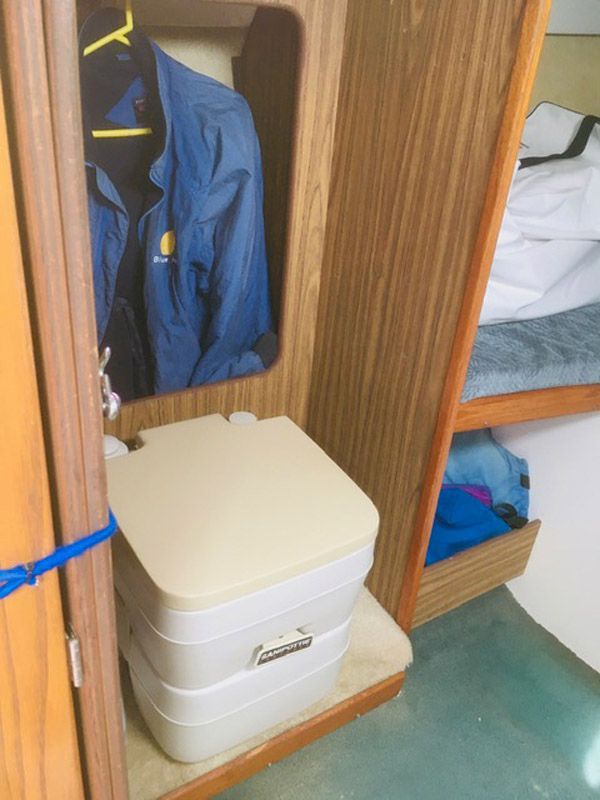 Interior of a 1975 O'Day Sloop with portable toilet.