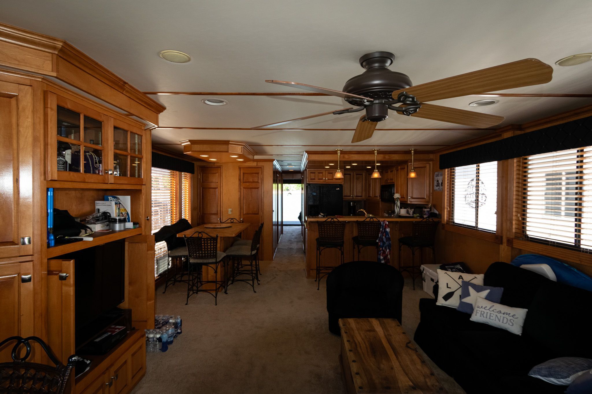 Interior of a 2003 Lakeview 16x70 houseboat with wooden furnishings.