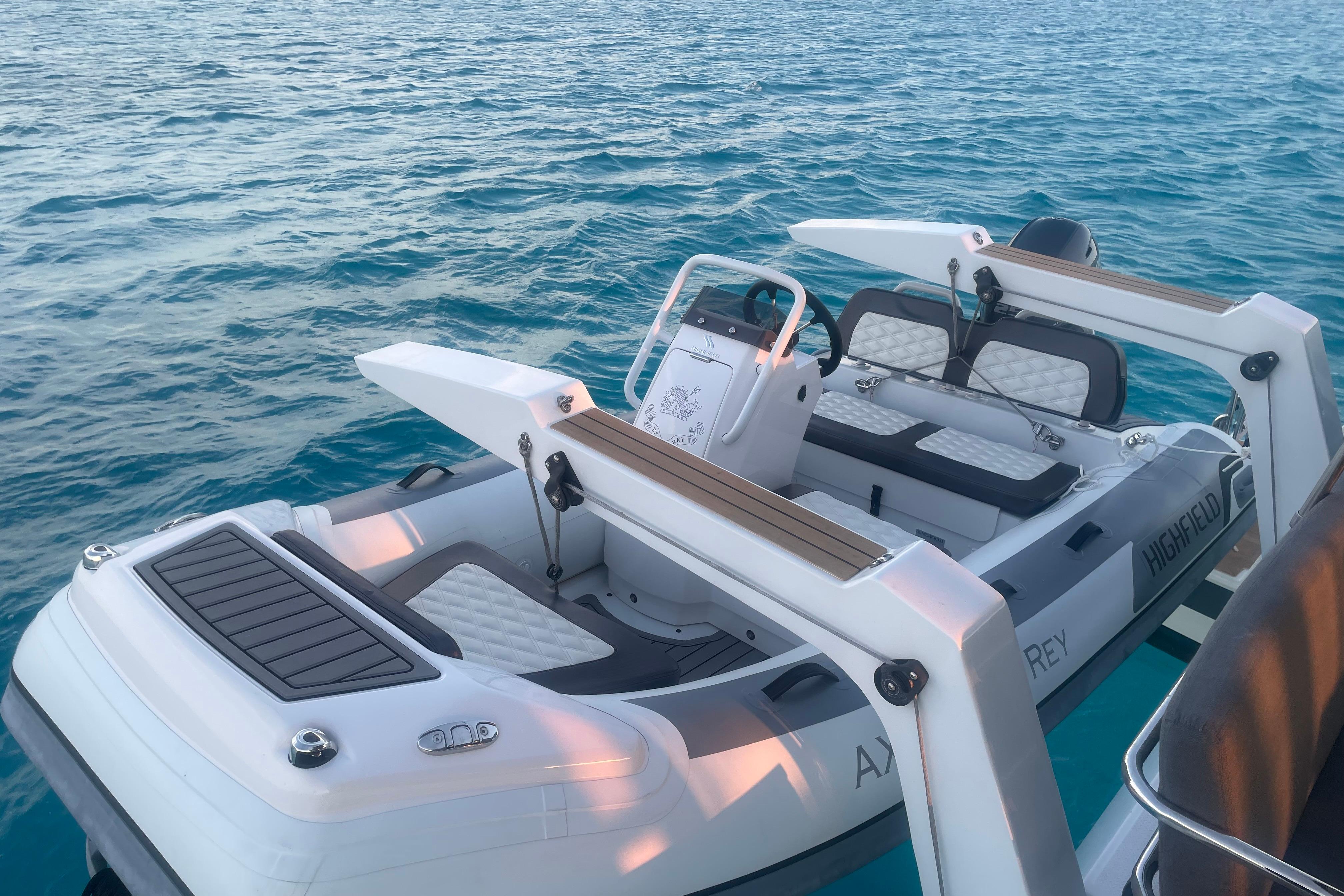 2020 Fountaine Pajot Saona 47 yacht with a Highfield tender on turquoise water.