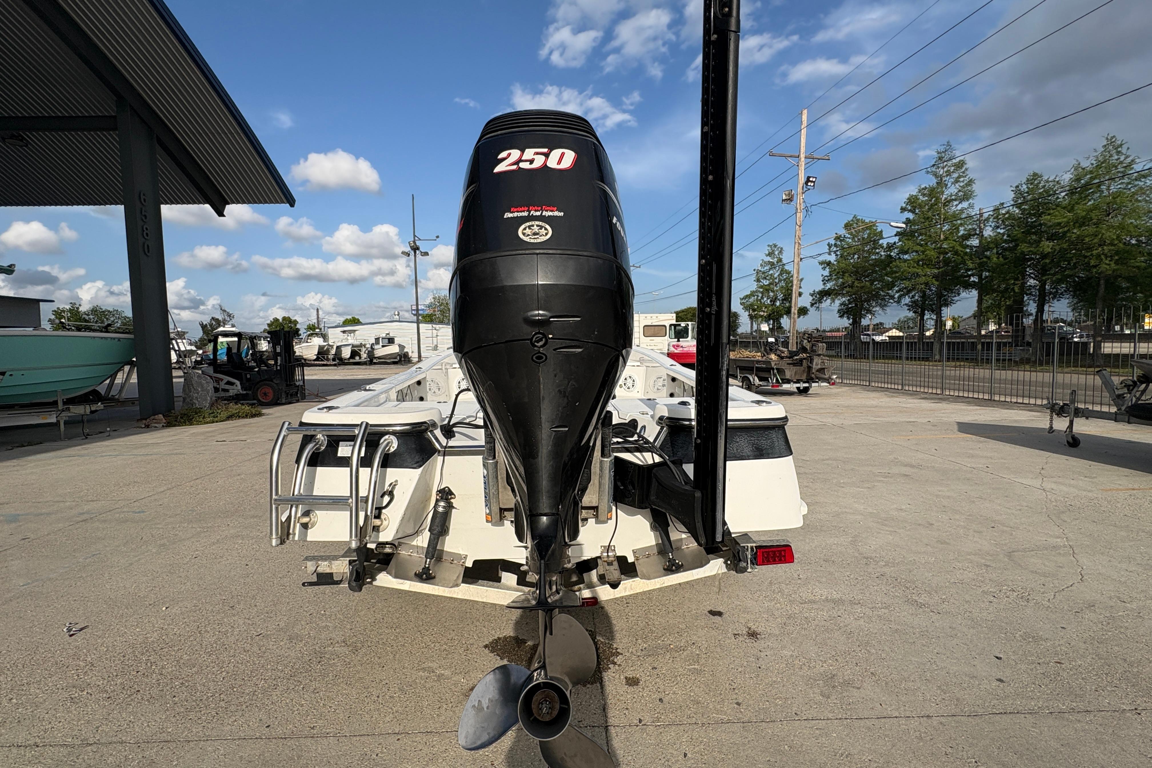 Rear view of a 2012 BlackJack 224 boat with a 250 HP outboard motor.