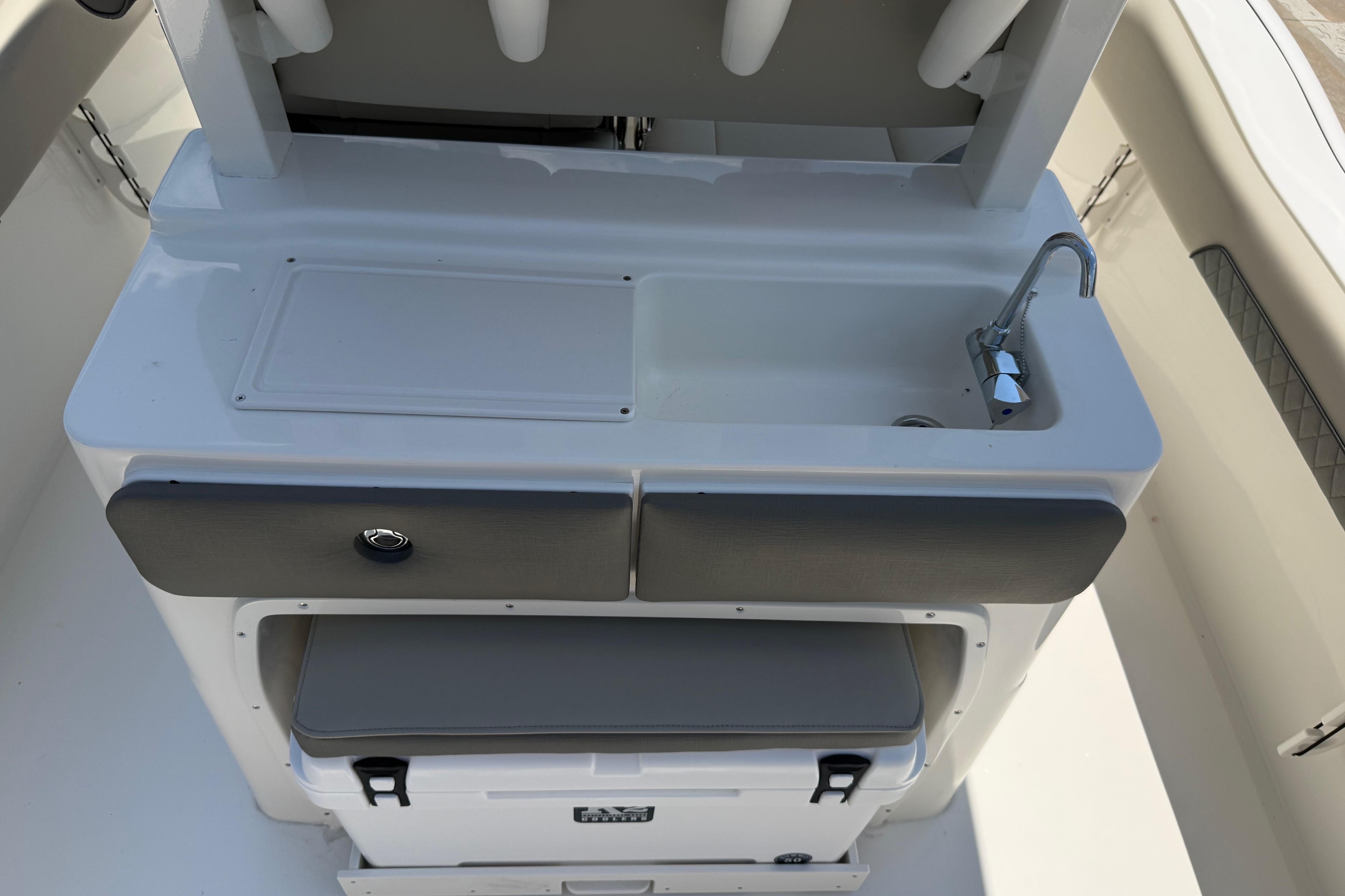 Key West 249 FS 2027 boat interior with sink and storage compartments.