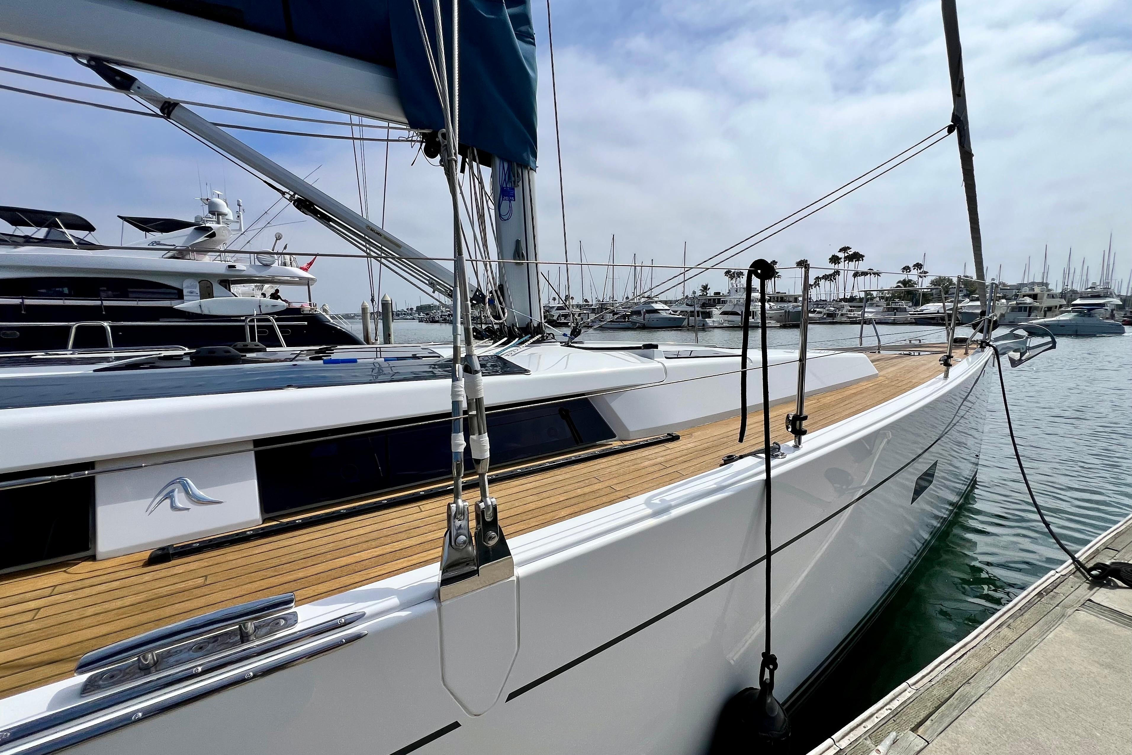 2016 Hanse 455 yacht docked at marina, showcasing sleek design and wooden deck.